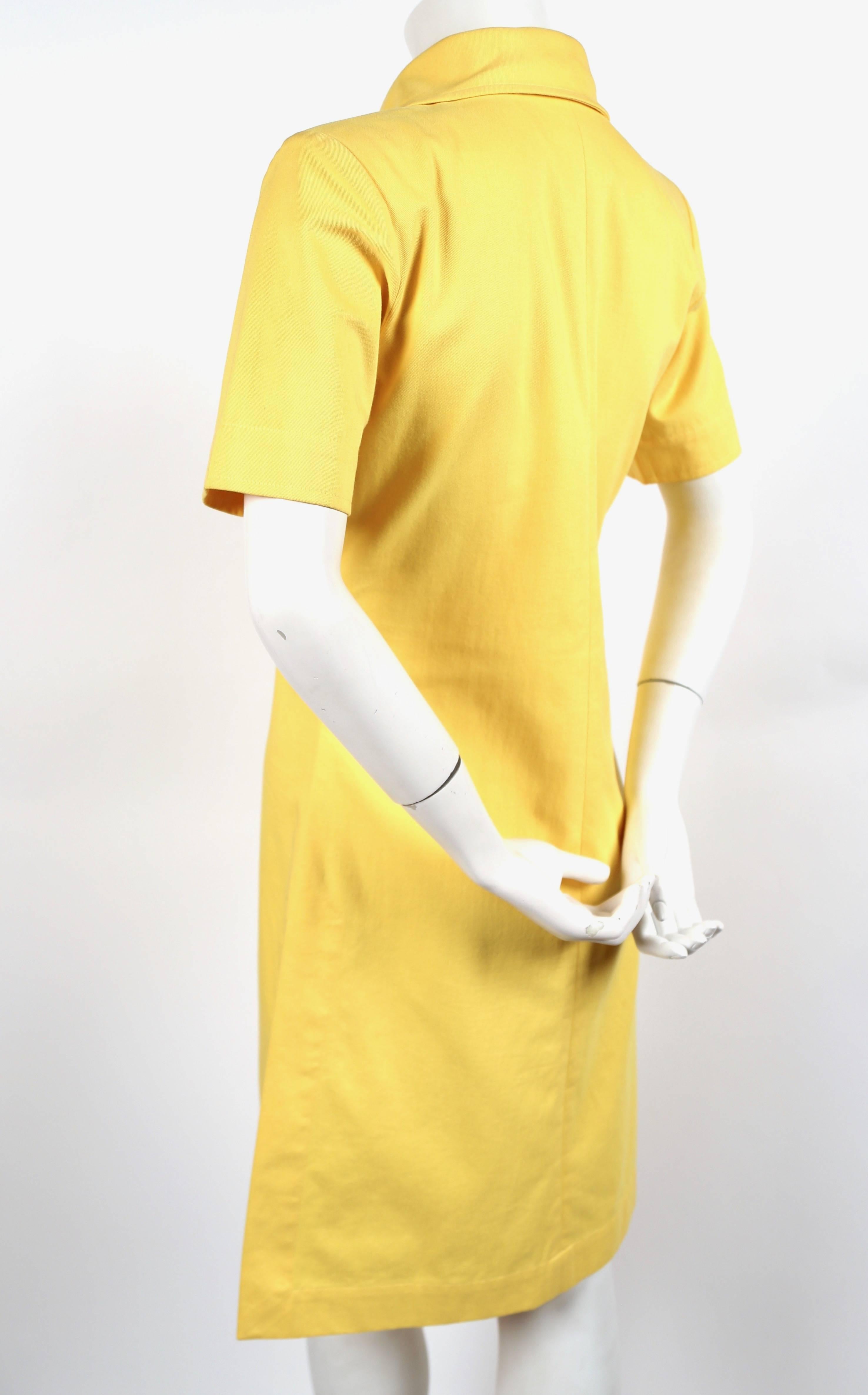 Very rare, vivid yellow safari dress with lace up front and side slit from Yves Saint Laurent dating to the late 1980's. French size 36. Best suited for a US 2 or 4. Lightly padded shoulders. Made in France. Excellent condition.
