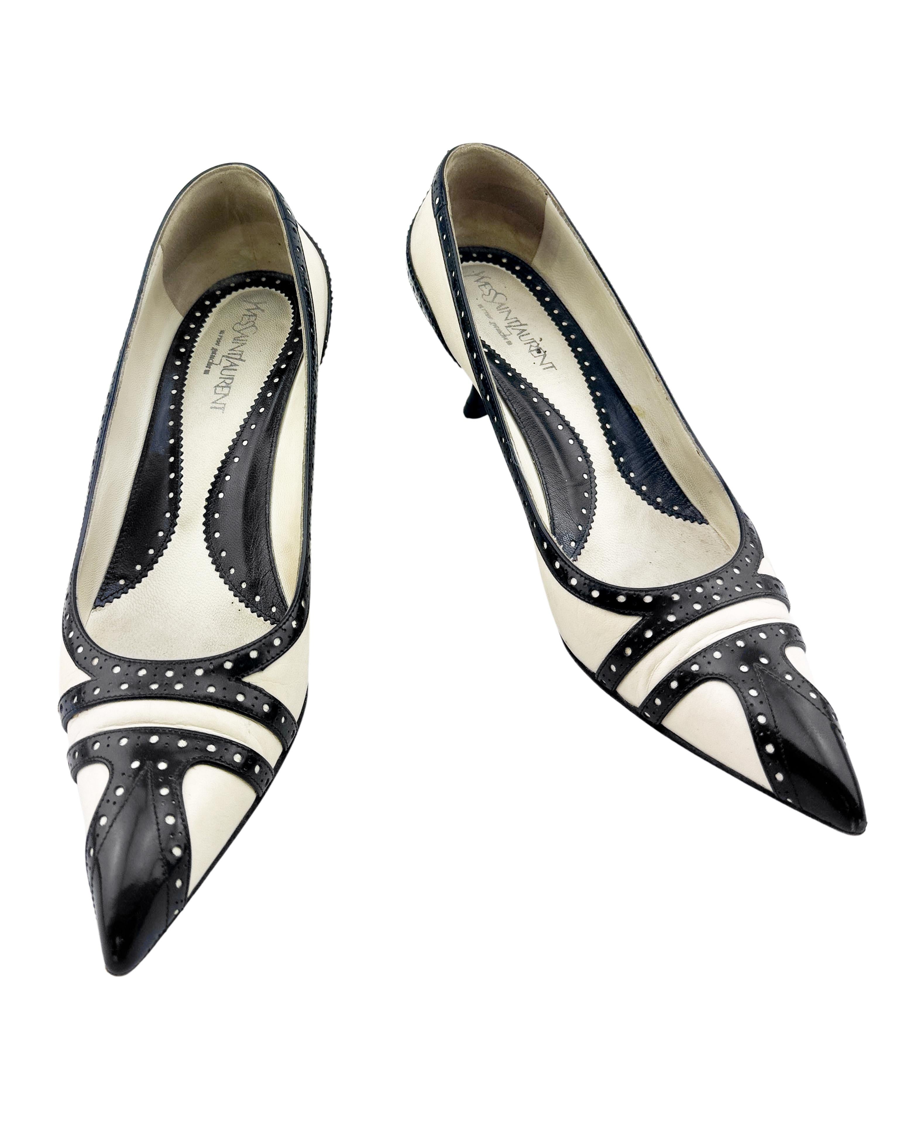 Very chic Yves Saint Laurent Rive Gauche kitten heels from the 1980's. White leather with contrasting black leather brogue details and heels. Elongated pointy toe and 1.5