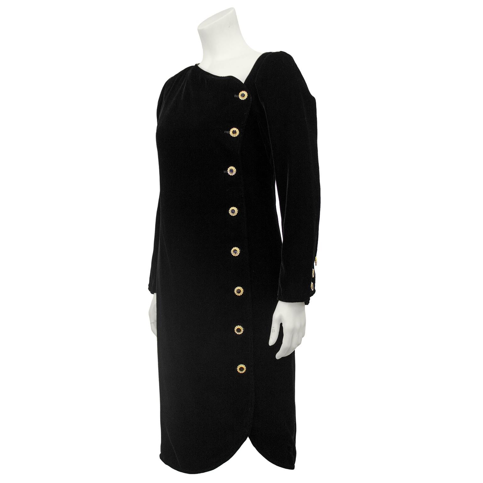1980s Yves Saint Laurent Rive Gauche jet black cut velvet cocktail dress. Asymmetrical neckline with long sleeves and rhinestone embellished gold and black buttons. Slightly fitted through the waist and features a tulip hem. Excellent vintage