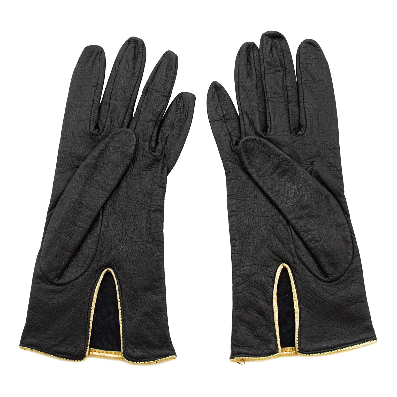 Gorgeous Yves Saint Laurent black leather gloves from the 1980s. Contrasting gold trim and gold studs. Lined in 100% silk. Made in Italy. Excellent vintage condition. Fit like a US 7 which is small.