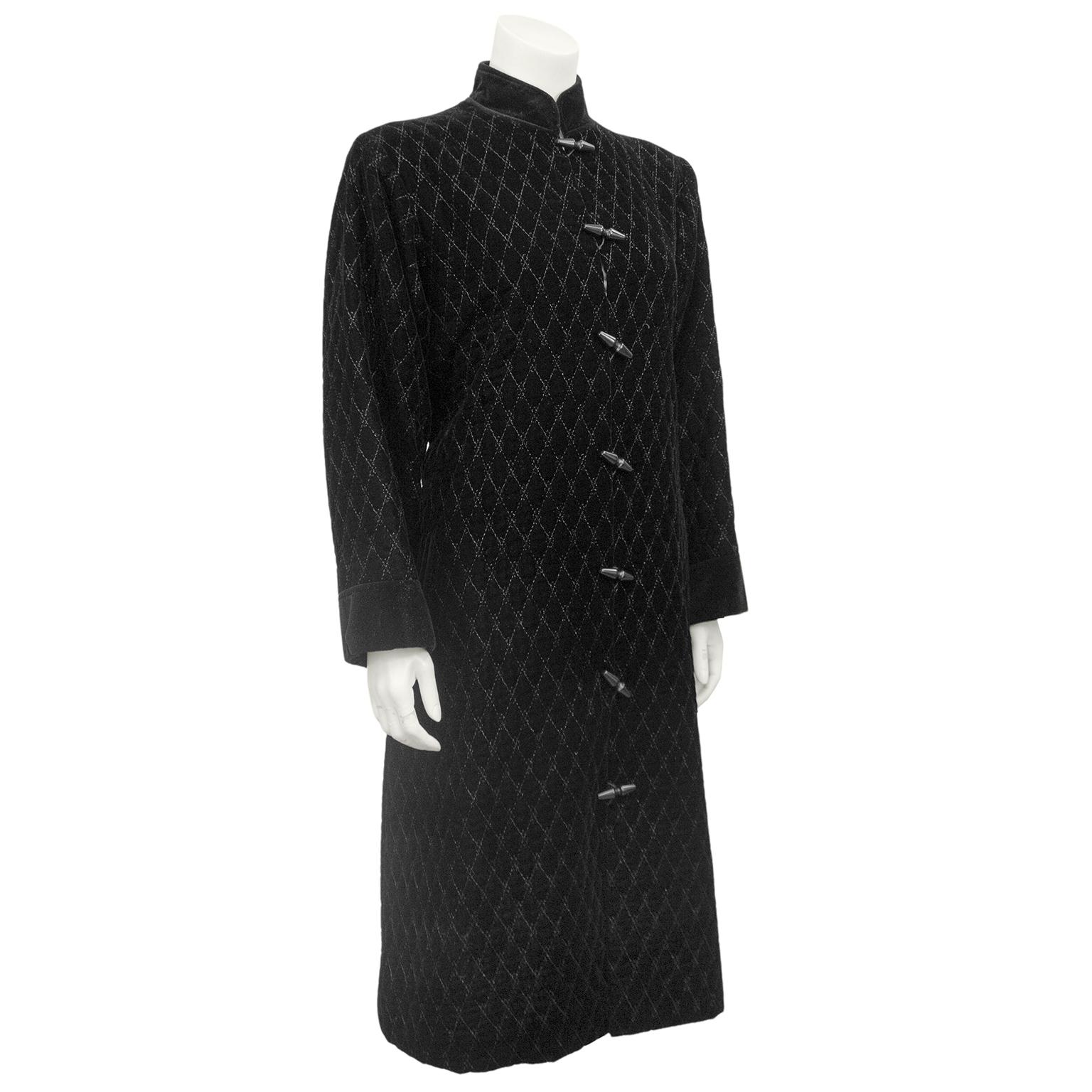 Yves Saint Laurent Rive Gauche robe stye coat from the 1980s. Black velvet with top stitching creating all over diamond quilting. Non quilted black velvet Mandarin collar, black cuffs and matching belt loops and waist belt. Belt can be tied as