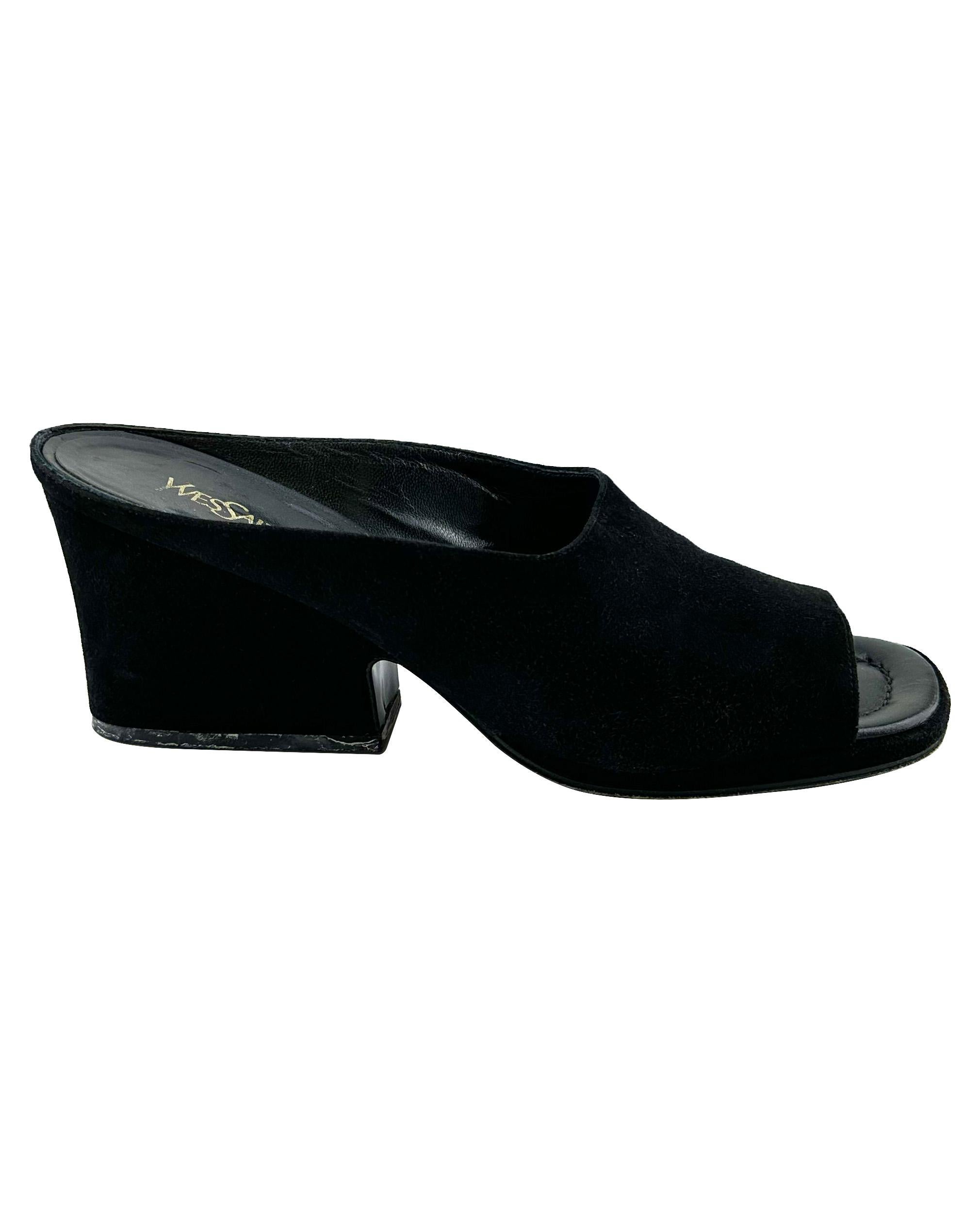 Yves Saint Laurent black suede mules from the 1980s. Open toe with a long rectangular wedge-like heel. Black leather interior sole with gold YSL markings and tonal top stitching. Minimalist and classic. Very good vintage condition - signs of wear to