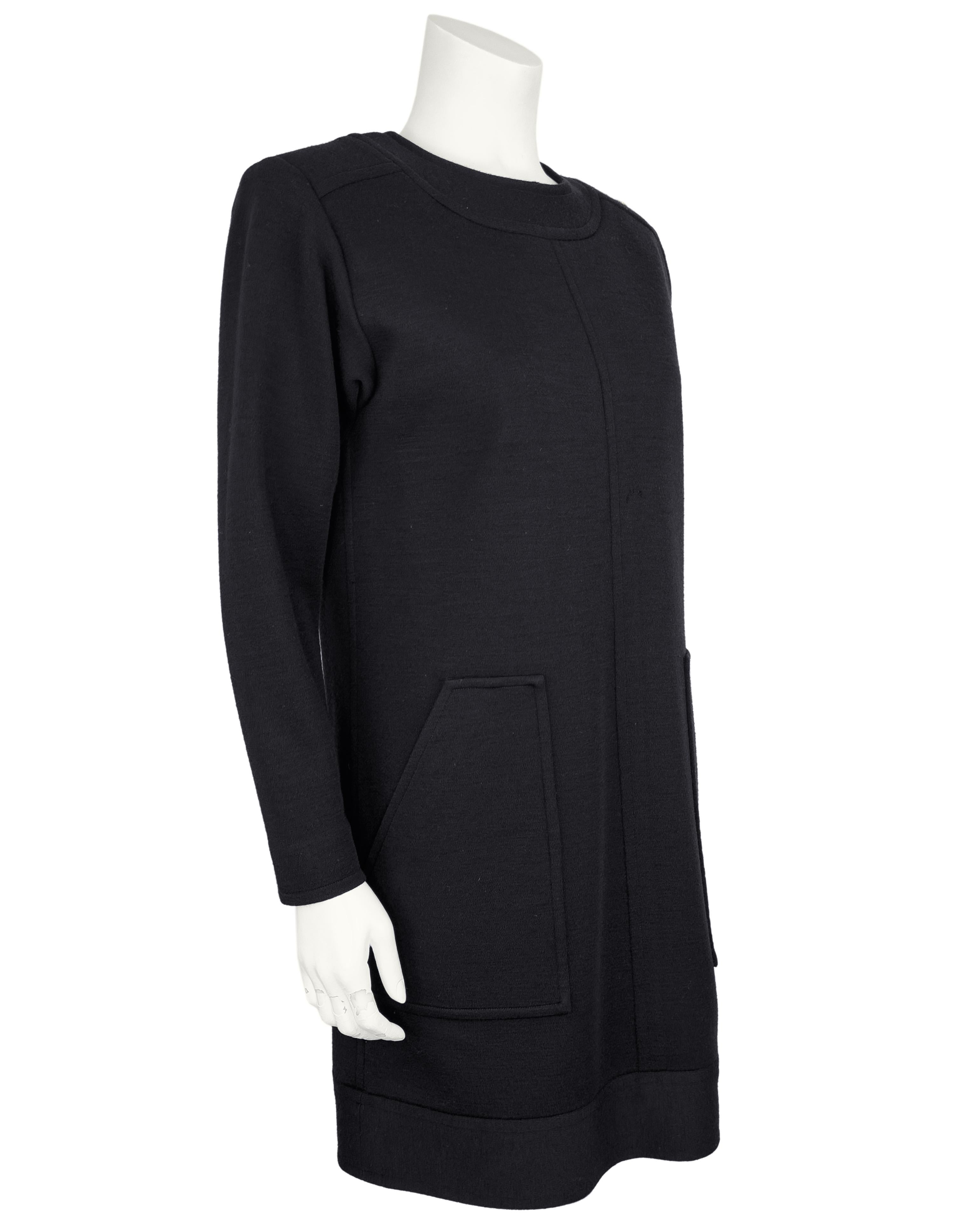 Step into timeless sophistication with this 1980s Yves Saint Laurent black wool dress. Crafted from a structured black wool, this long sleeve dress features a sleek, straight shift silhouette with subtle seaming and a refined crew neckline. Two