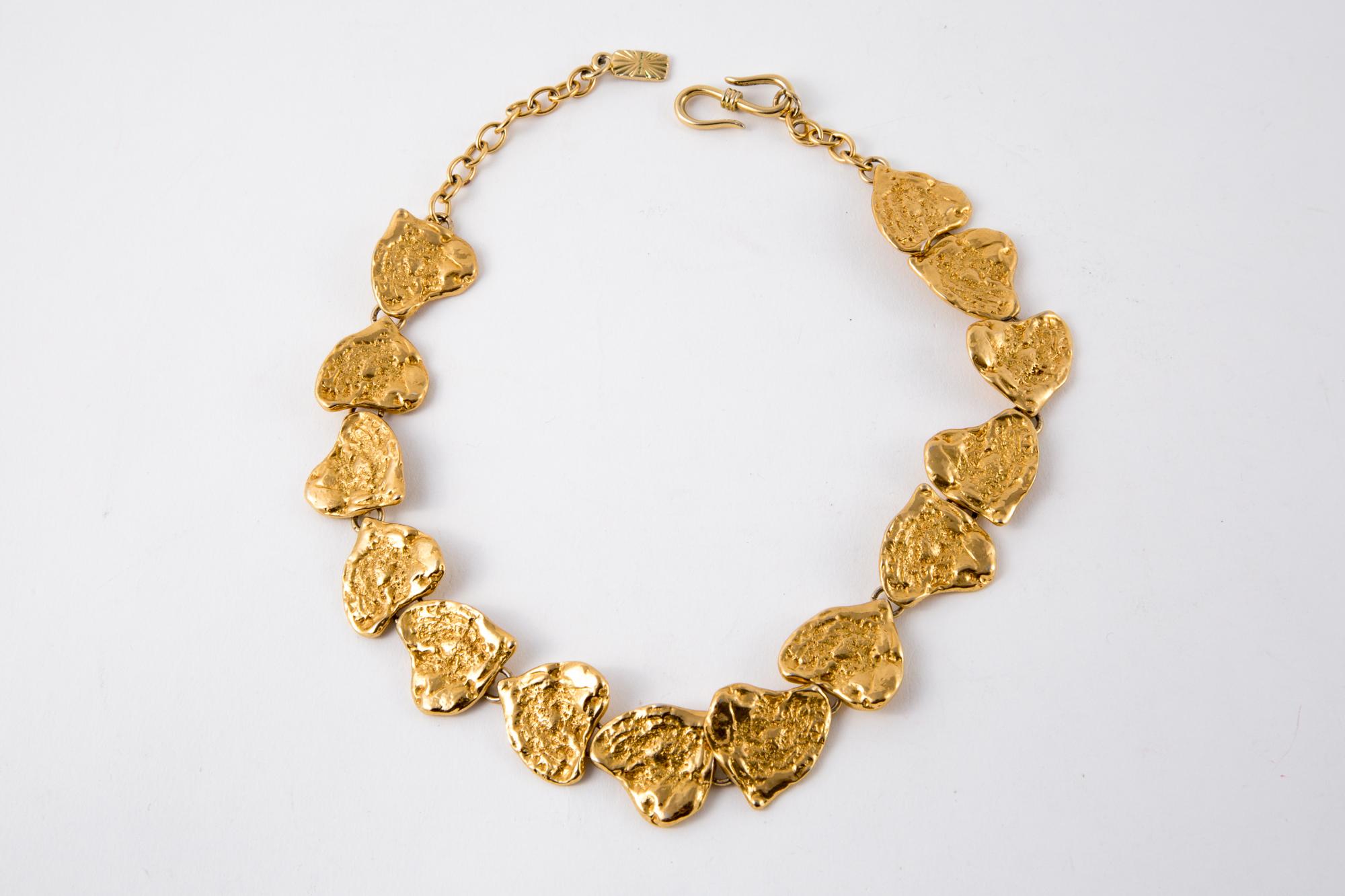  1980s Yves Saint Laurent gold-tone hearts necklace featuring textured irregular hearts, an adjustable chain, a hook closure, a back YSL pitted plaque.
Designed by Goossens.
 Maxi length: 20.4in. (52 cm)
Heart YSL Width 1in (2.5cm)
In excellent