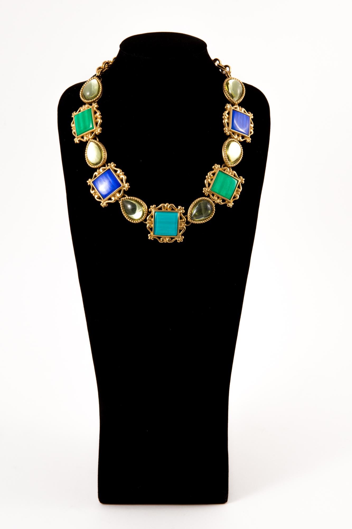Yves Saint Laurent multicolor necklace featuring gold-plated parts, glass beads, blue & green stones, hearts pitted YSL to get it adjustable, a bar closing. 
Assorted clip-on earrings available on 1st Dibs.
Circa: 1980s
In excellent vintage