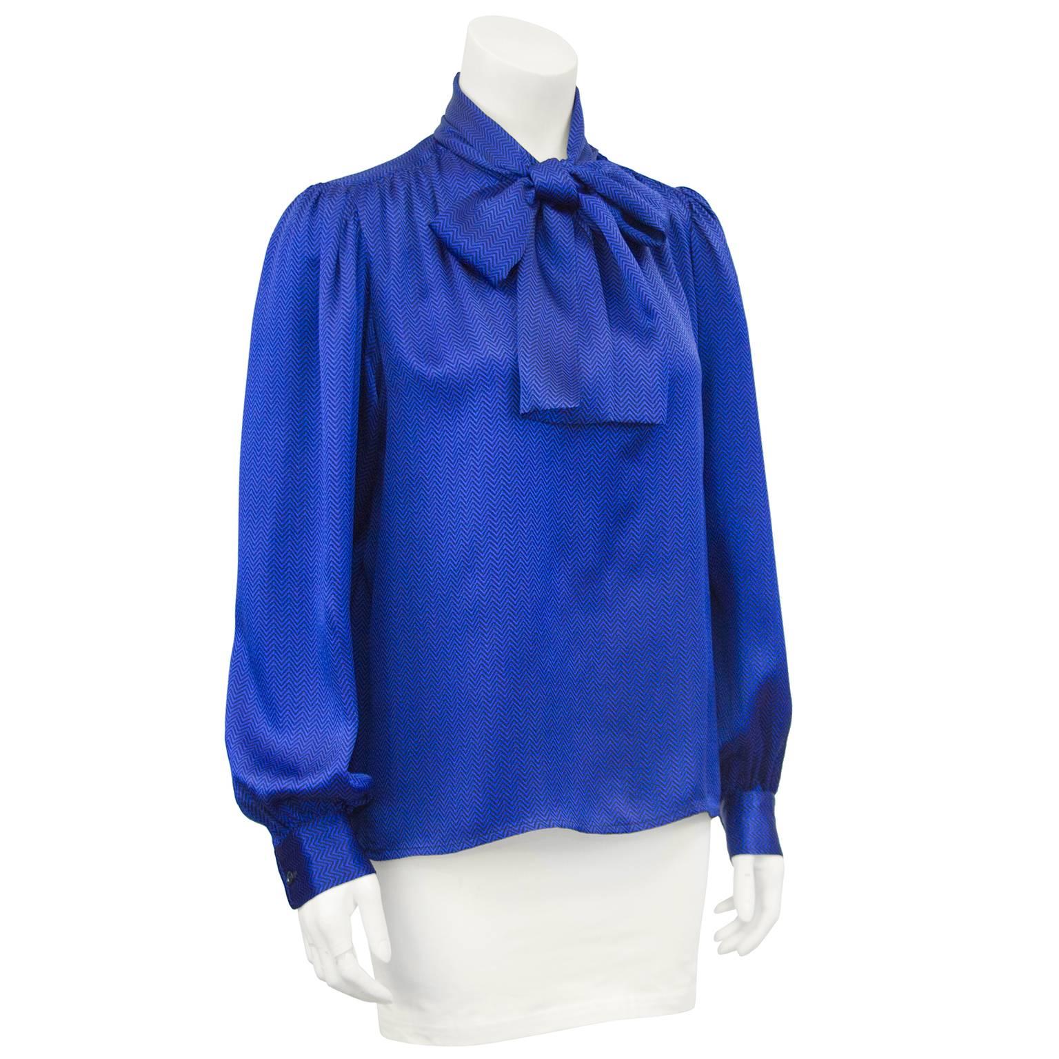 1980s Yves Saint Laurent cobalt blue silk blouse. Small black chevron print throughout. Large pussy bow tie at neck and bishop sleeves. Excellent vintage condition. Marked size FR 40 - fits like a US 6. 

sleeve 24.5 , shoulder 16 , bust 44 , waist