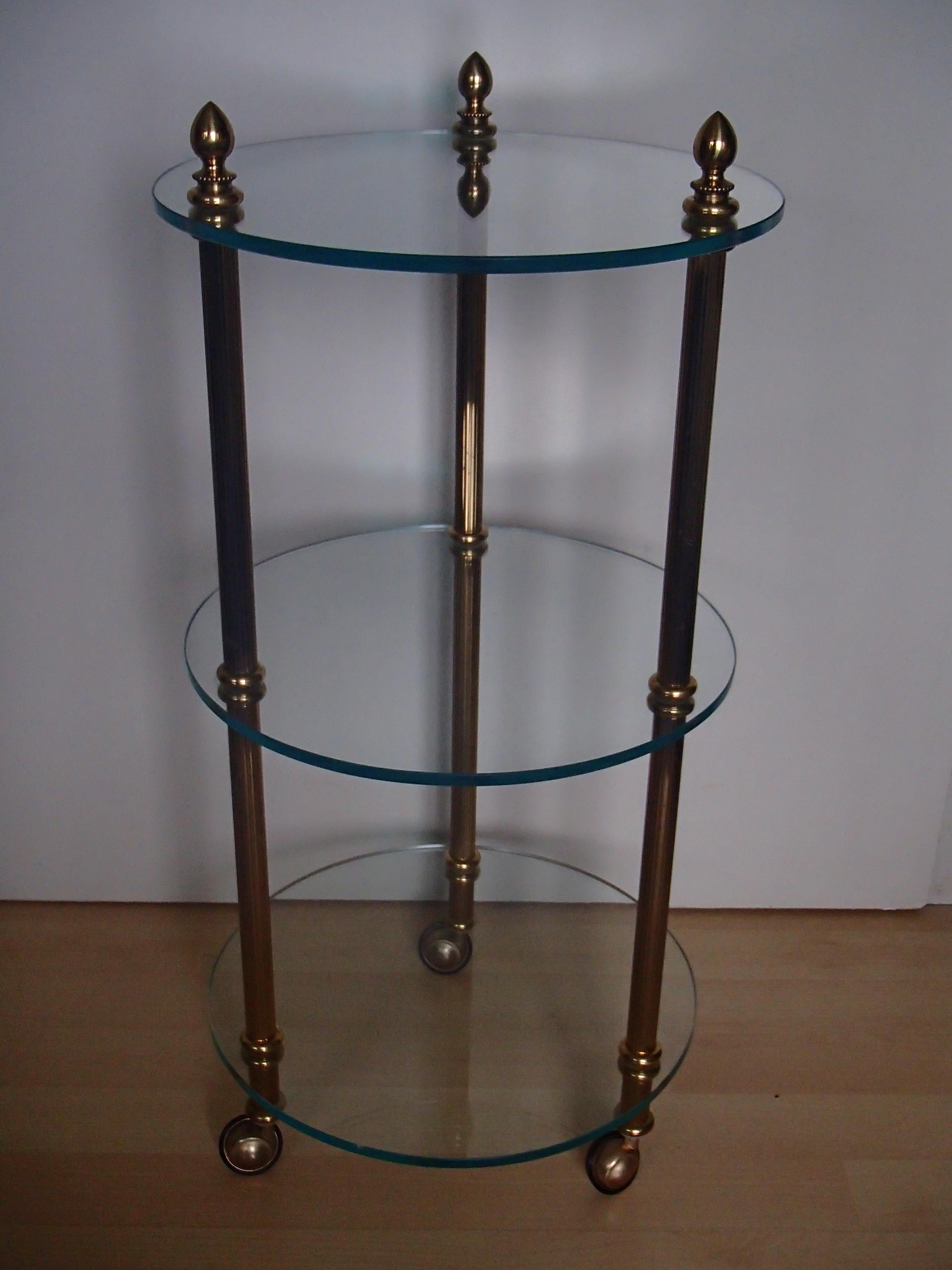 1980 this small round 3 top trolley brass and glass 
Heavy and high end quality.