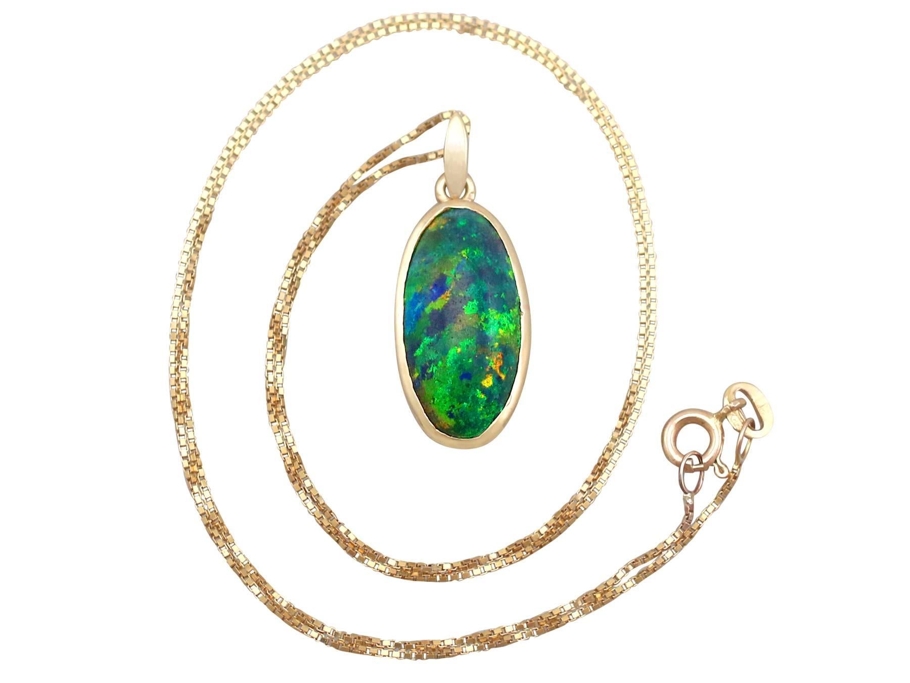 An impressive vintage 3.82 carat black opal and 9 karat yellow gold pendant and chain; part of our diverse opal jewelry and estate jewelry collections.

This fine and impressive black opal pendant has been crafted in 9k yellow gold.

The oval shaped