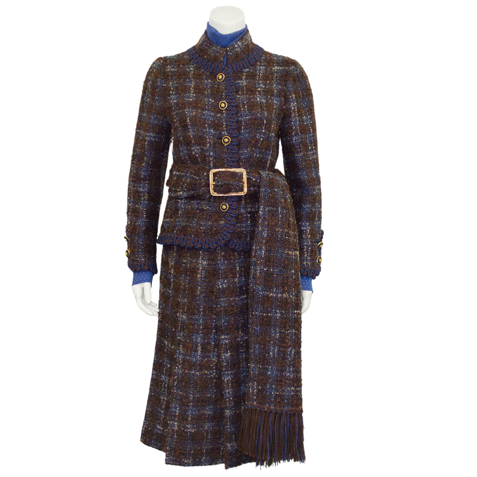 Show stopping 1981 blue and brown tweed Chanel Haute Couture five piece ensemble including a jacket, blouse, cuff links, skirt and scarf/belt. Mandarin collar jacket with patch pockets and blue and brown passementarie trim. Gold and navy blue round