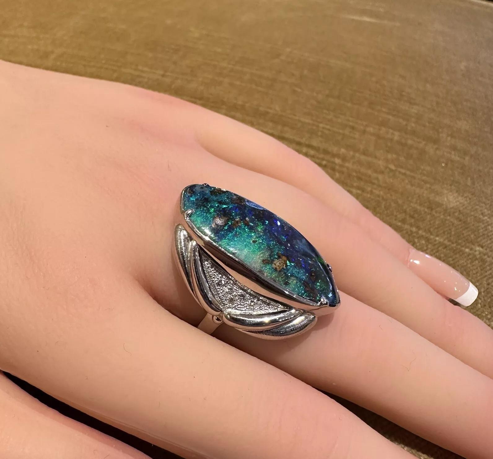 19.82 carat Boulder Opal and Diamond Ring in Platinum

Diamond and Boulder Opal Ring features one Elongated Boulder Opal weighing 19.82 carats with Blue and Green play of color accented by Round Brilliant Diamonds, all set in Platinum.

Total