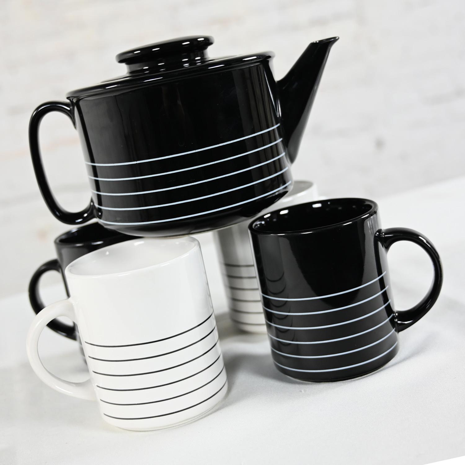 Marvelous 1982 Modern to Postmodern Copco black & white glazed ceramic lidded teapot, 2 white mugs with black stripes, and 2 black mugs with white stripes, designed by Sam Lebowitz.  Beautiful condition, keeping in mind that this is vintage and not