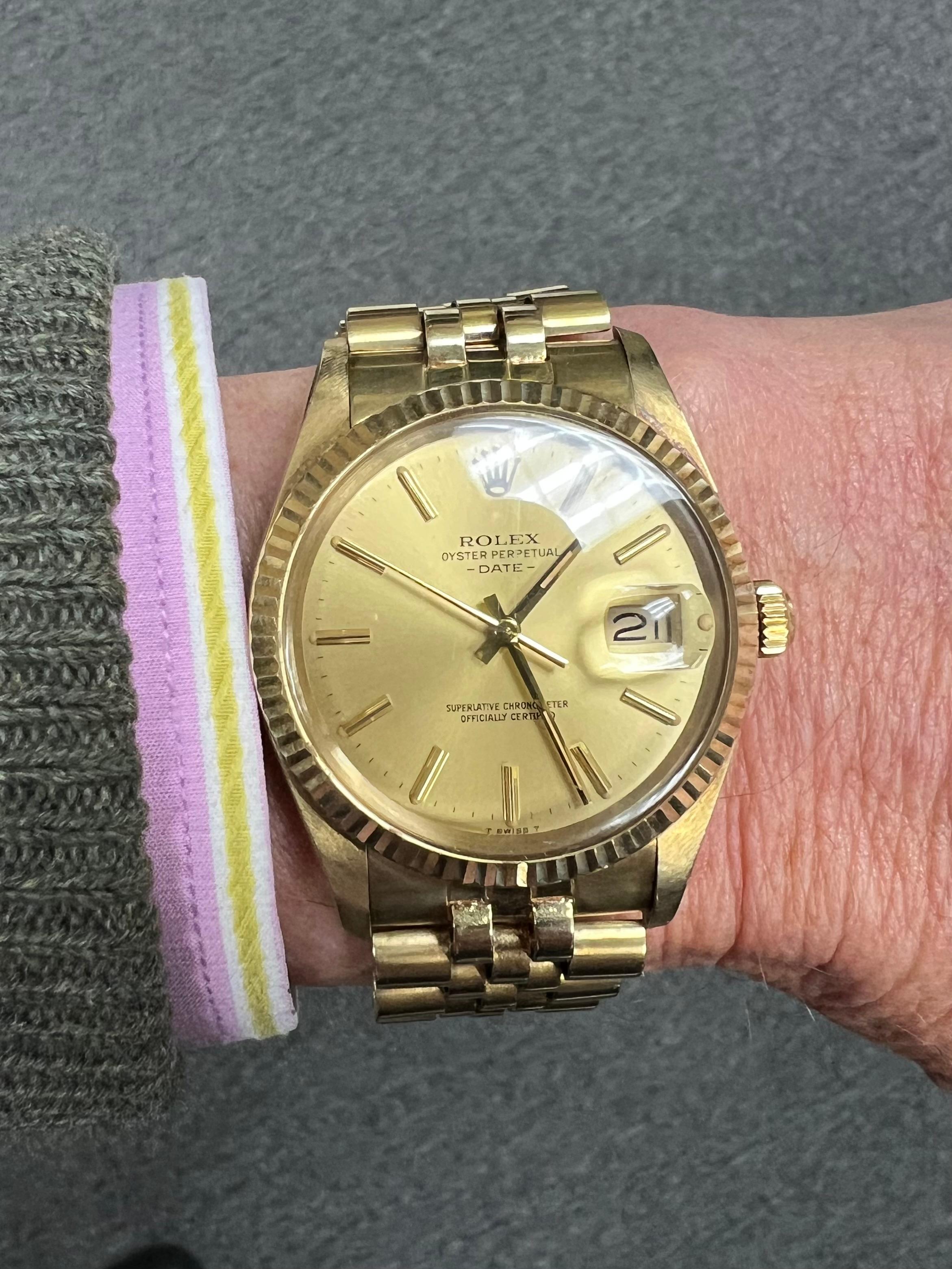 1982 Rolex Oyster Perpetual Date 14k Yellow Gold Wristwatch.

This Rolex Oyster Perpetual Date wristwatch from 1982 features a refined 34mm case crafted from 14k yellow gold.  The watch is powered by an automatic movement, model #15037 with a