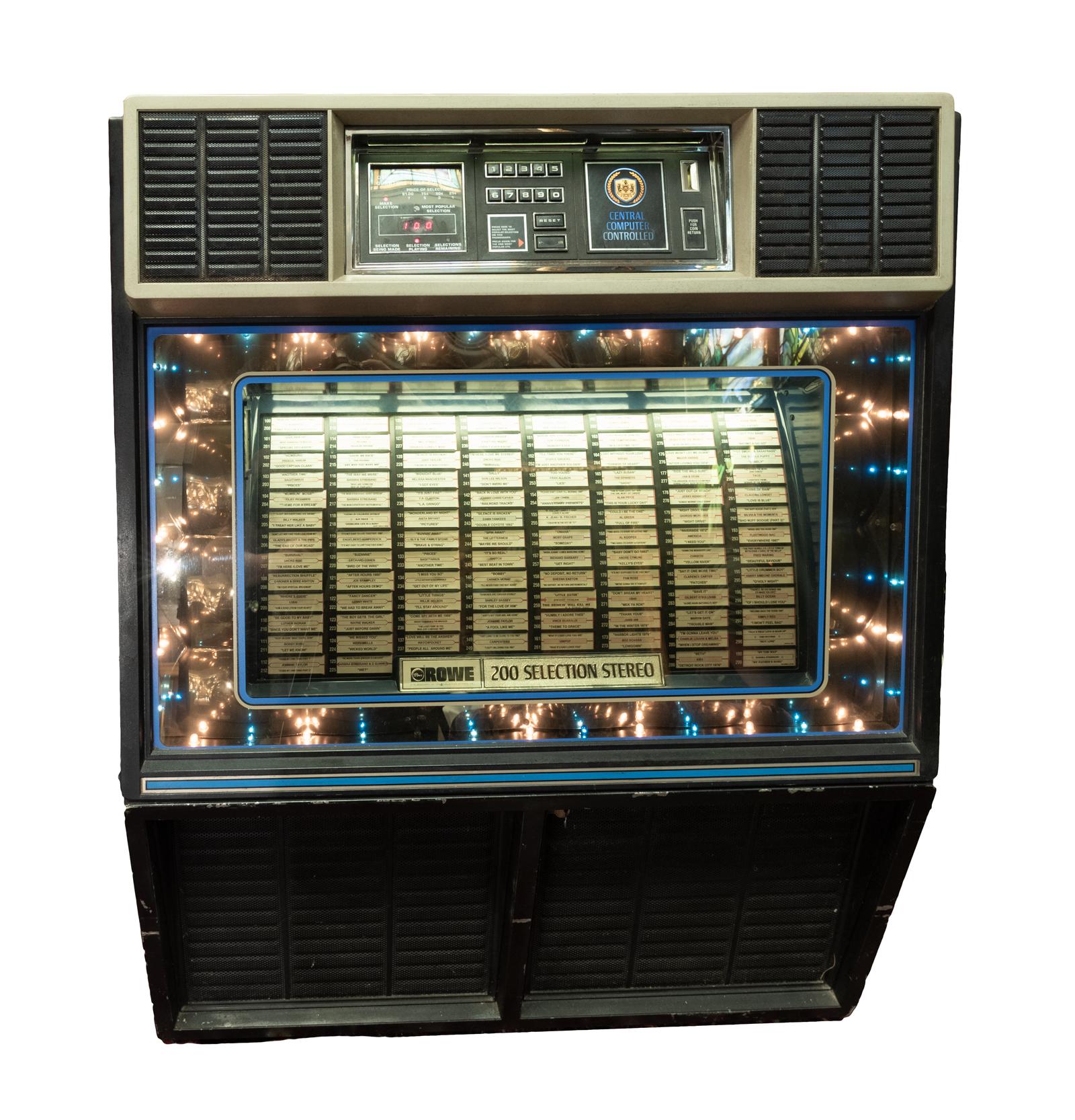 1982 Rowe jukebox model R86, 100 45 RPM vinyl records. This beautiful unrestored Rowe Ami R86 vinyl jukebox in working condition has 200 selections and plays 7 inch records at 45 RPM. Includes 100 records and original service manual. The model was