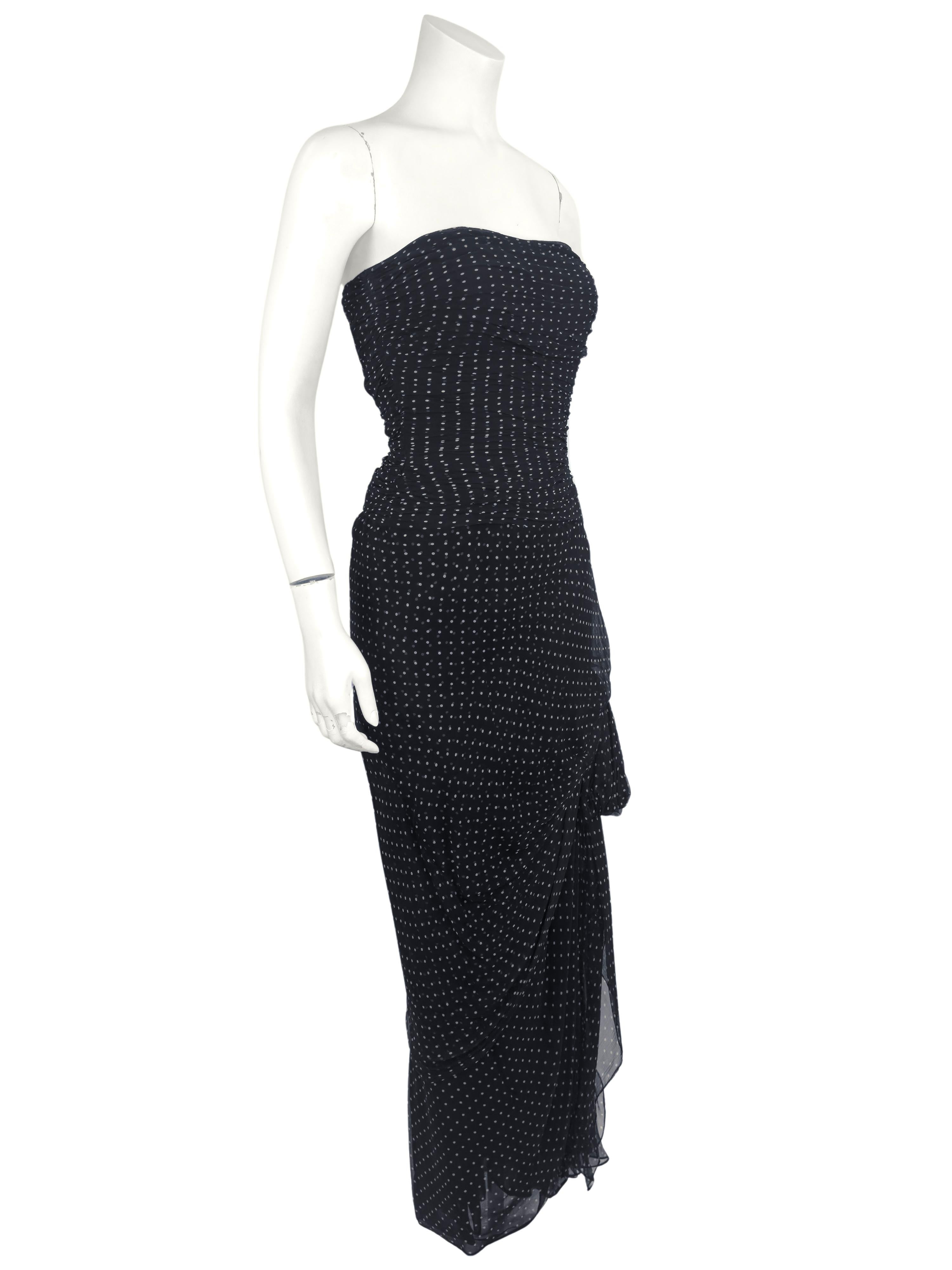 From the 1982 Oscar de la Renta Summer RTW collection. The black chiffon ruched and draped micro polka dot gown with gathered bow is elegant and timeless. Constructed with an interior bustier that fastens at the waist, side zipper closure.