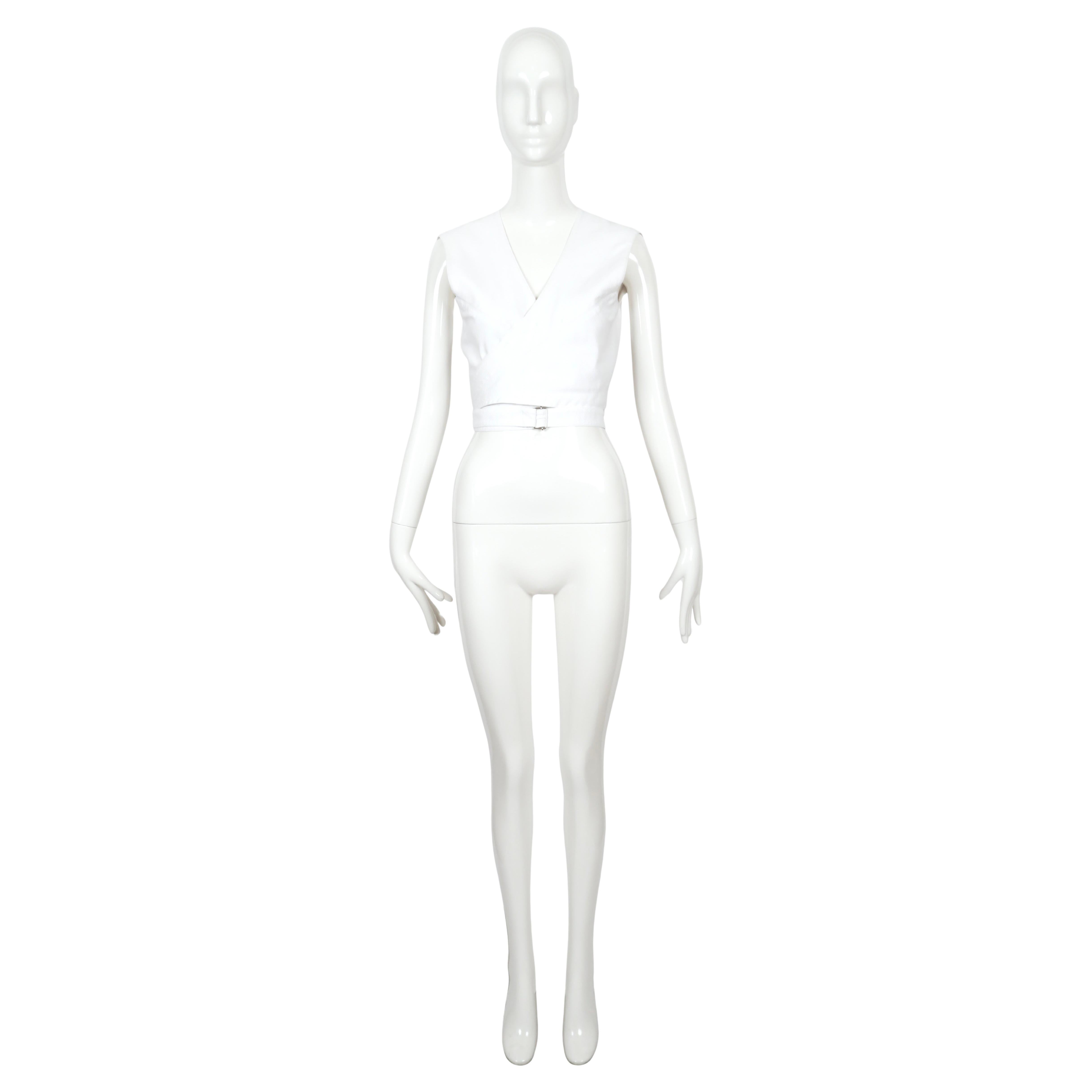 Very rare, white cotton pique wrap top designed by Azzedine Alaia dating to summer of 1983. I have included a photo of the piece in leather from fall of 1982. Since this is from one of Alaia very first collections so it is extremely hard to find.