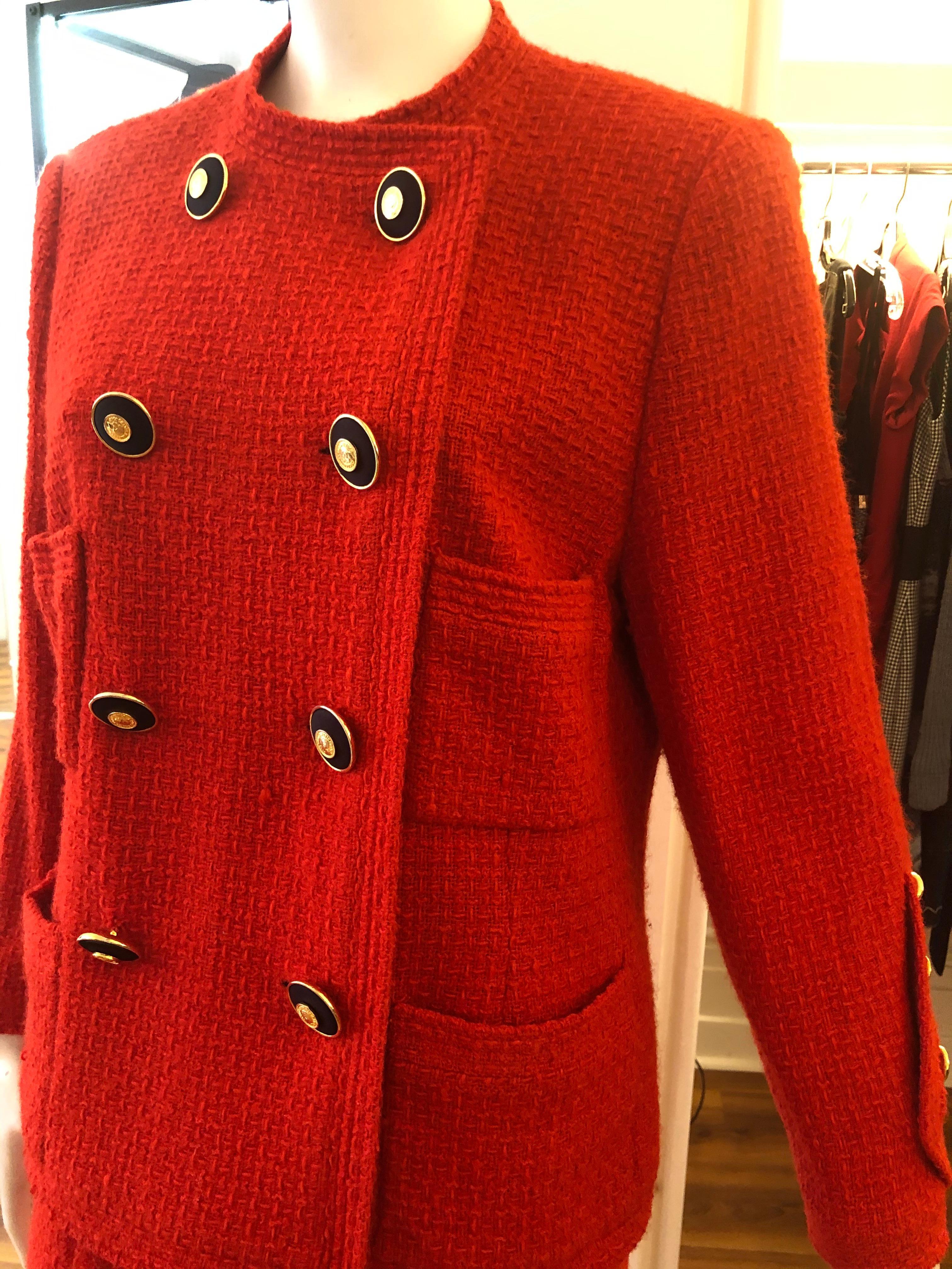 Featured in Emma Baxter-Wright's book Chanel, this red boucle wool suit is from Karl Lagerfeld's first collection for the House of Chanel. The fitted jacket has a double row of gilt buttons, and four pockets, whilst the skirt has a false double
