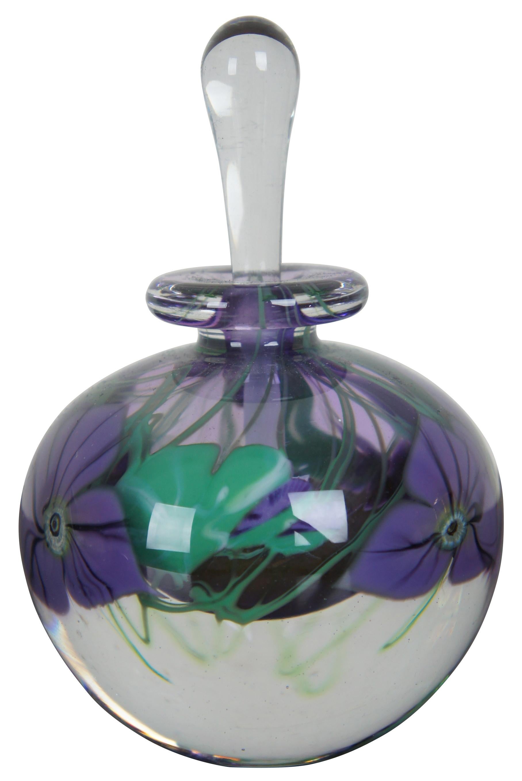Mary Angus 1983 hand blown art glass perfume bottle and stopper with an injected design of black veined, purple flowers and green leaves. Measure: 6