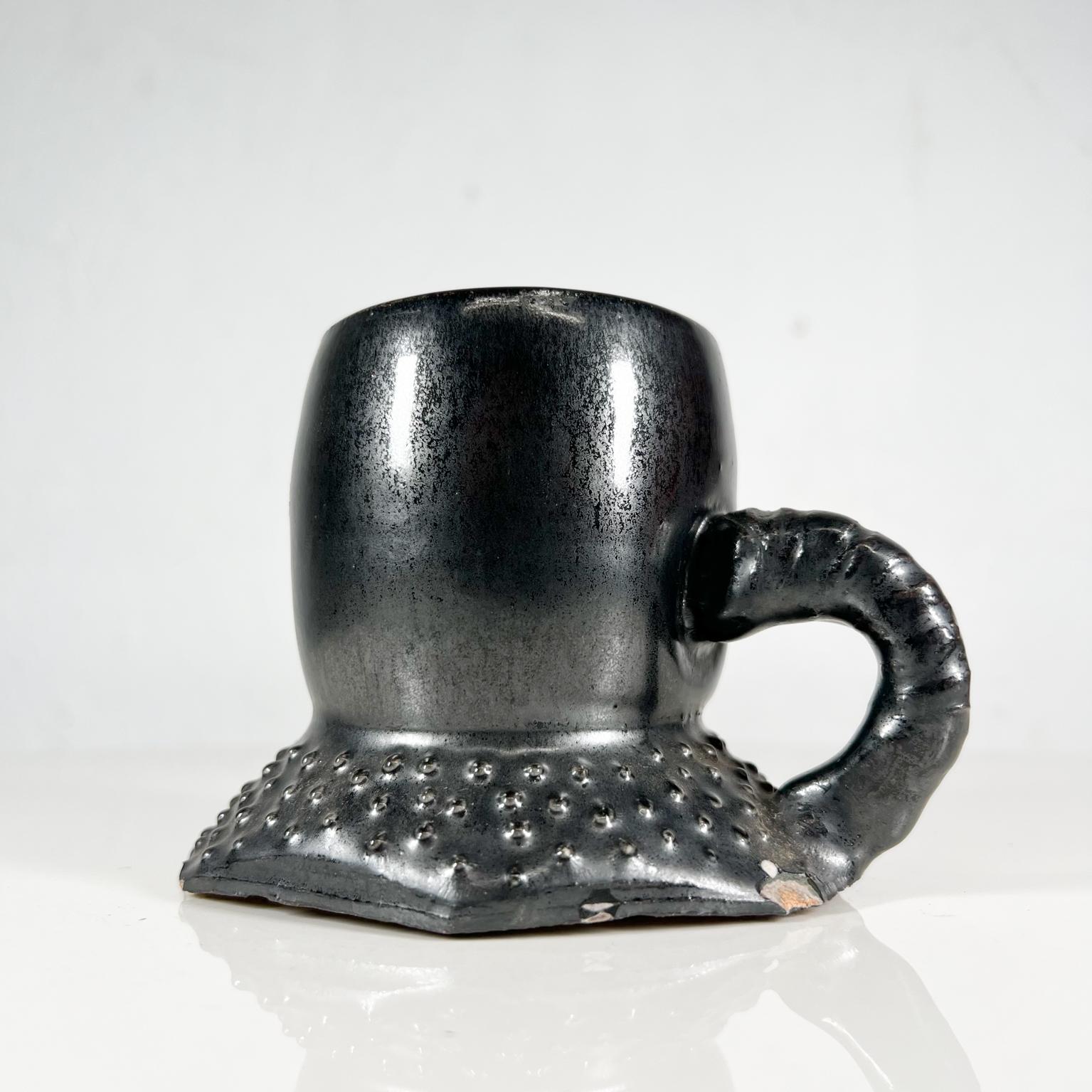 1980s black pottery art coffee cup mug vintage condition
Artist signed Melching 1983
Measures: 3 tall x 3.63 width x 5 depth
Unrestored vintage condition with chipping.
Please see all images.
  
