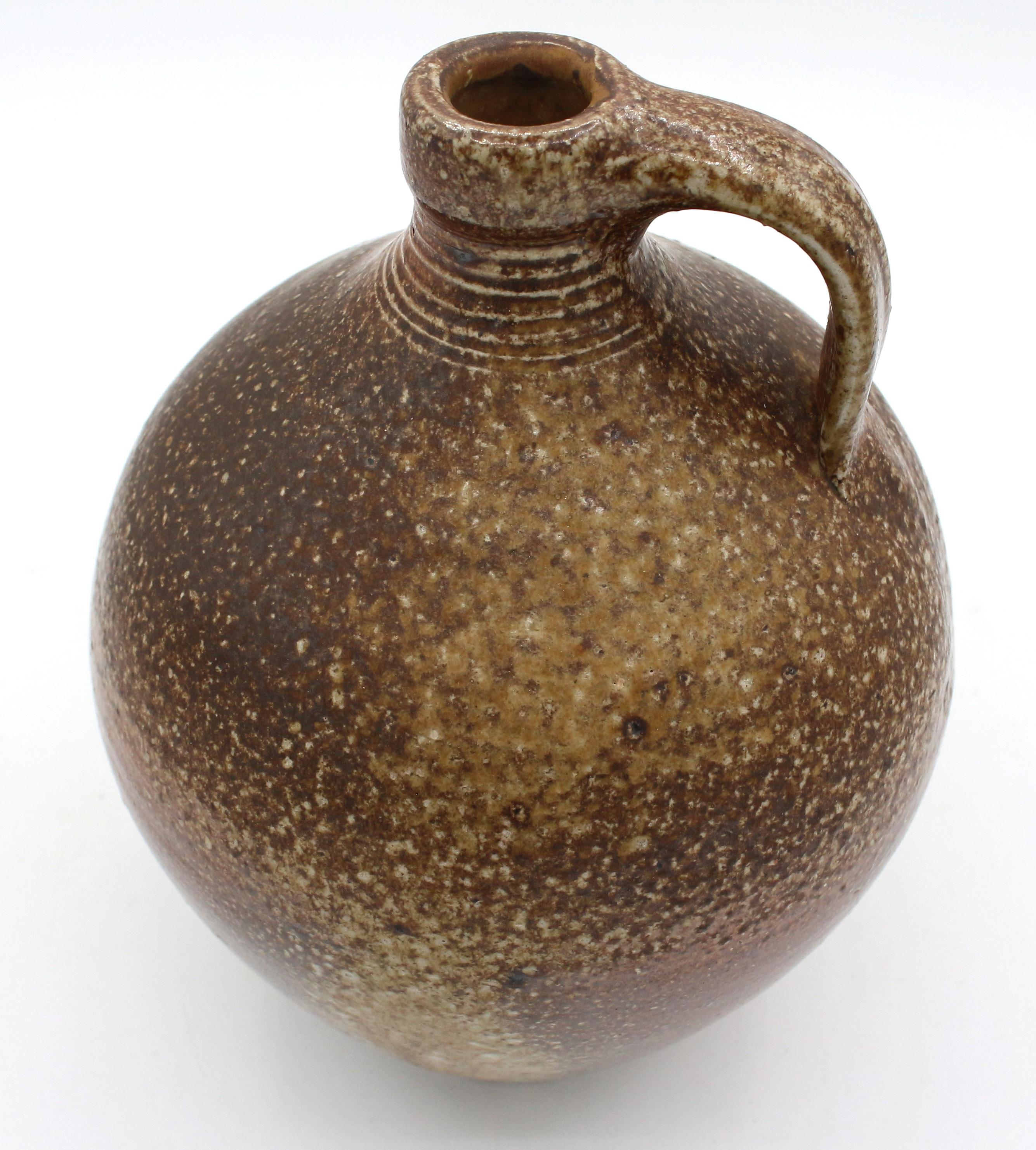 1984-1995 Mark Hewitt Pottery jug. Speckled brown; elegantly turned. WMH mark with a D.
7.75