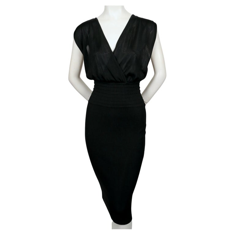 Very rare, jet-black dress with elasticized waist and draped bodice from Azzedine Alaia dating to 1984. Labeled a size 'S'. Approximate measurements (unstretched): bust is open, waist 23.5