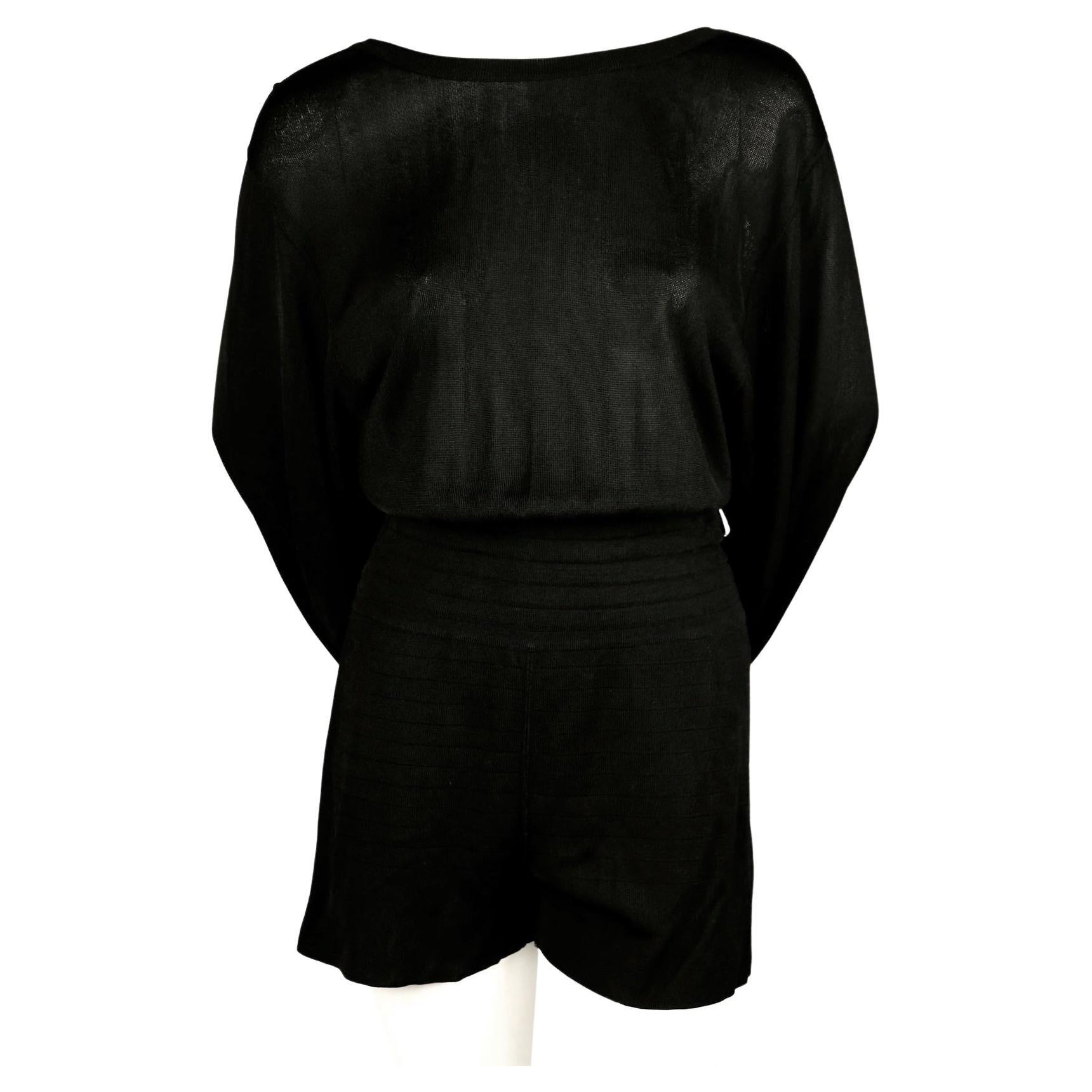 Jet-black summer playsuit with matching skirt that cleverly hooks onto waistband to create a unique draped silhouette designed by Azzedine Alaia dating to the late 1980's. Looks great worn during day or night. Would be a wonder travel piece. Labeled