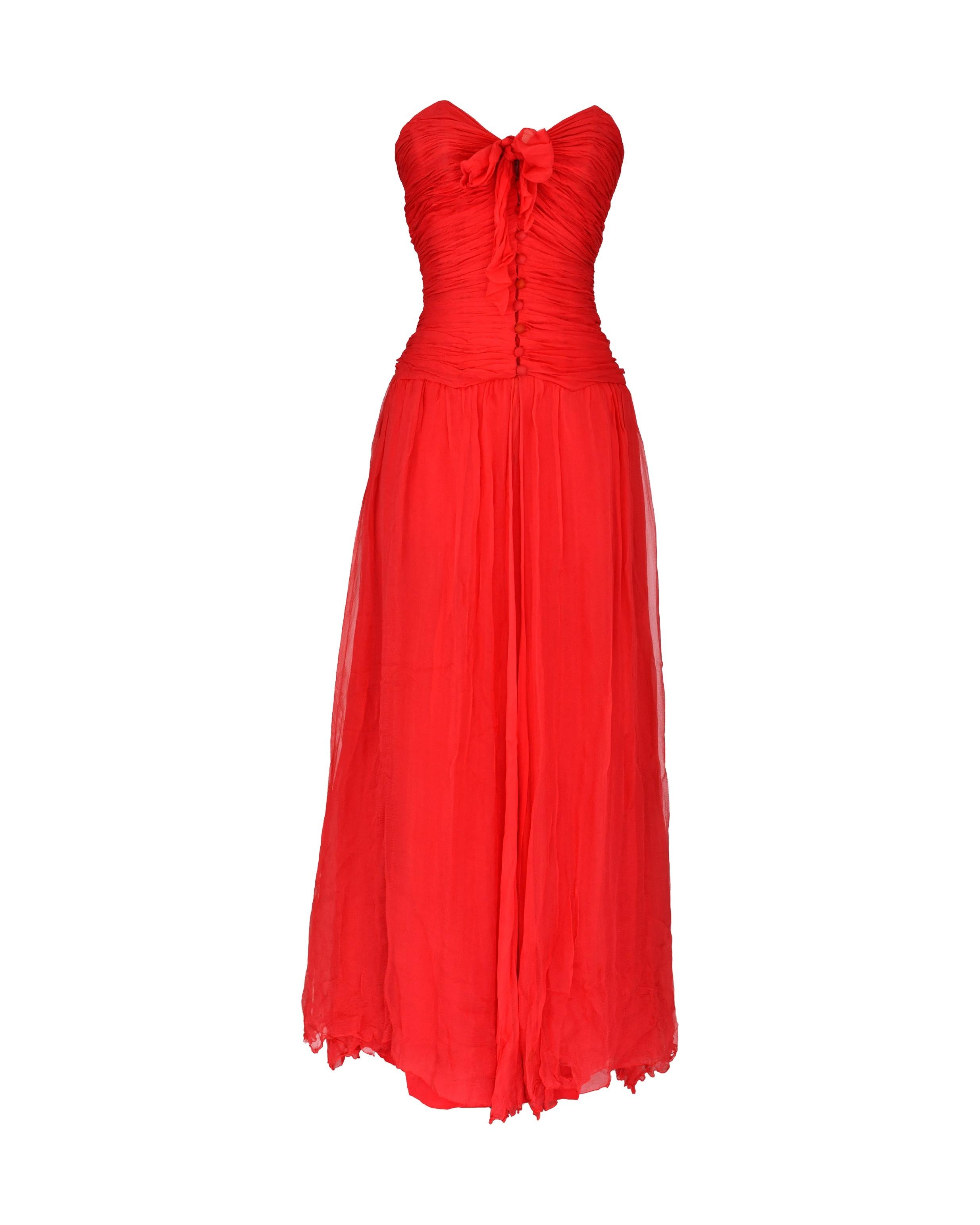 1984 Chanel by Karl Lagerfeld red floor length silk chiffon gown with corset bodice that buttons up the front to a small, delicate bow. Matching chiffon stole to style and wrap around in a variety of ways. Chiffon layers cut on the bias at hem