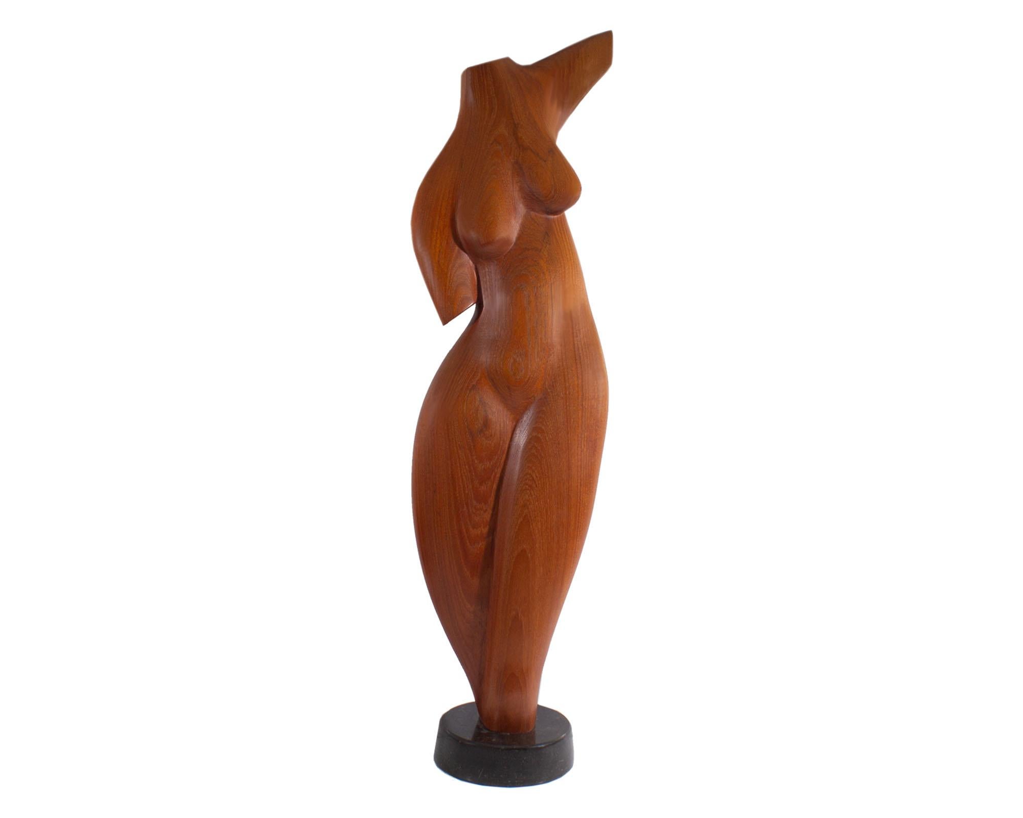 A 1984 abstract wood sculpture of a nude woman carved by Danish-American sculptor Gert Olsen (born 1937). Signed 