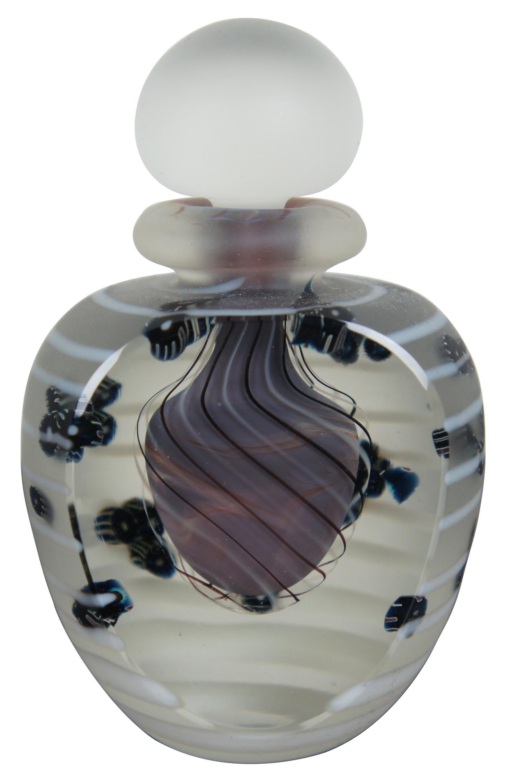1984 signed art glass perfume bottle and stopper, made of satin glass with white stripes and one flattened crystal clear side showing off suspended black striped beads and a pale purple swirled reservoir. Measure: 5