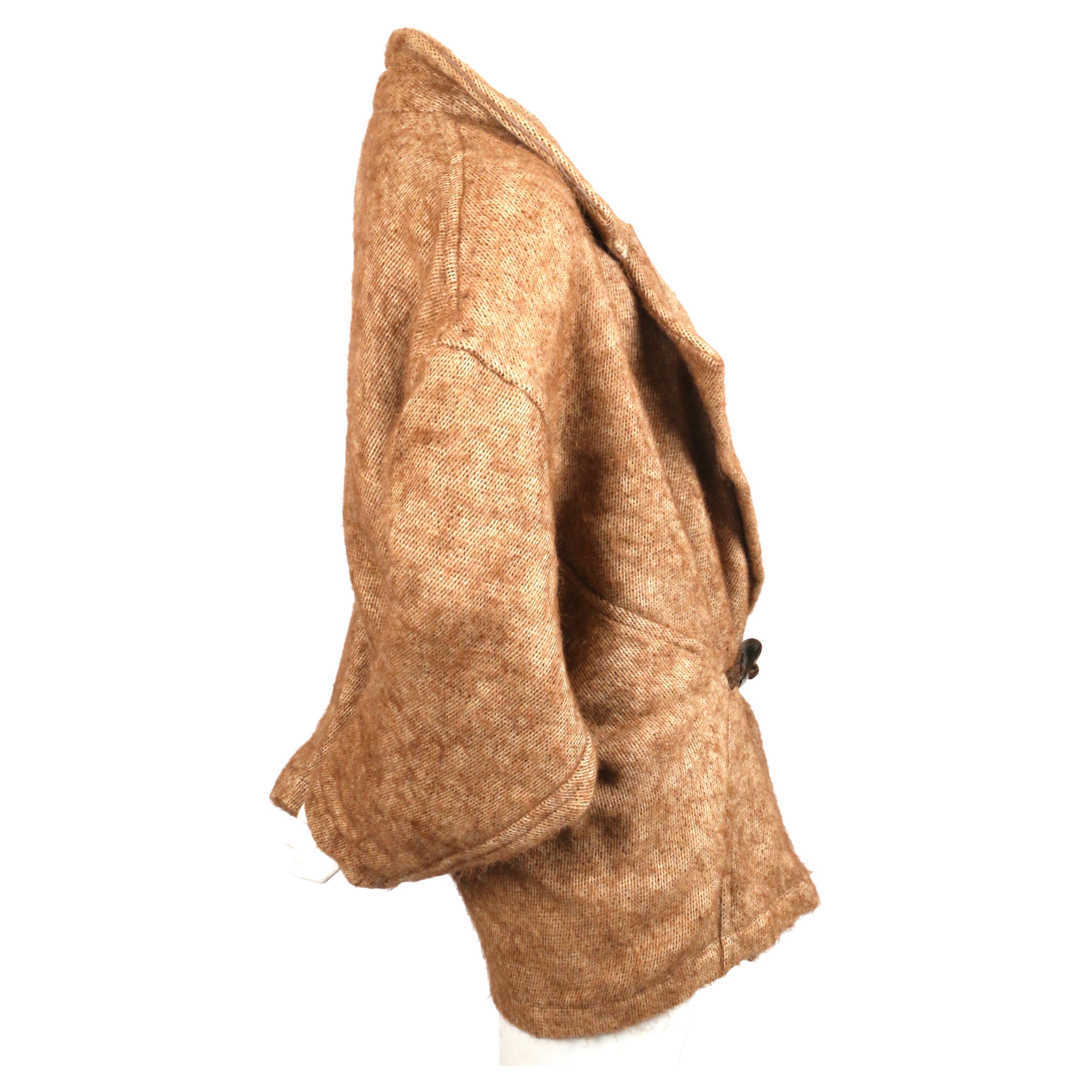 Brown alpaca and linen coat with leather and horn toggle closure designed by Issey Miyake dating to the 1984 as seen on the runway. Has a beautiful draped fit around the high hip area. Japanese size S. Approximate measurements: shoulder 24” , bust