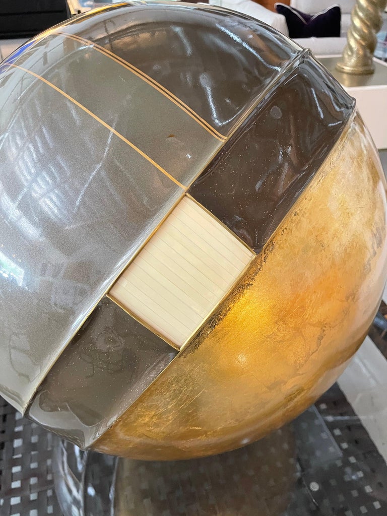 Quite beautiful large 24 inch globe in gold leaf with bone inlay by the design team of Gene Jonson and Robert Marcius for Jonson Cornell Ltd from 1984. Swivels on a pivot and the base is gold leafed as well. The globe is signed on the bottom in