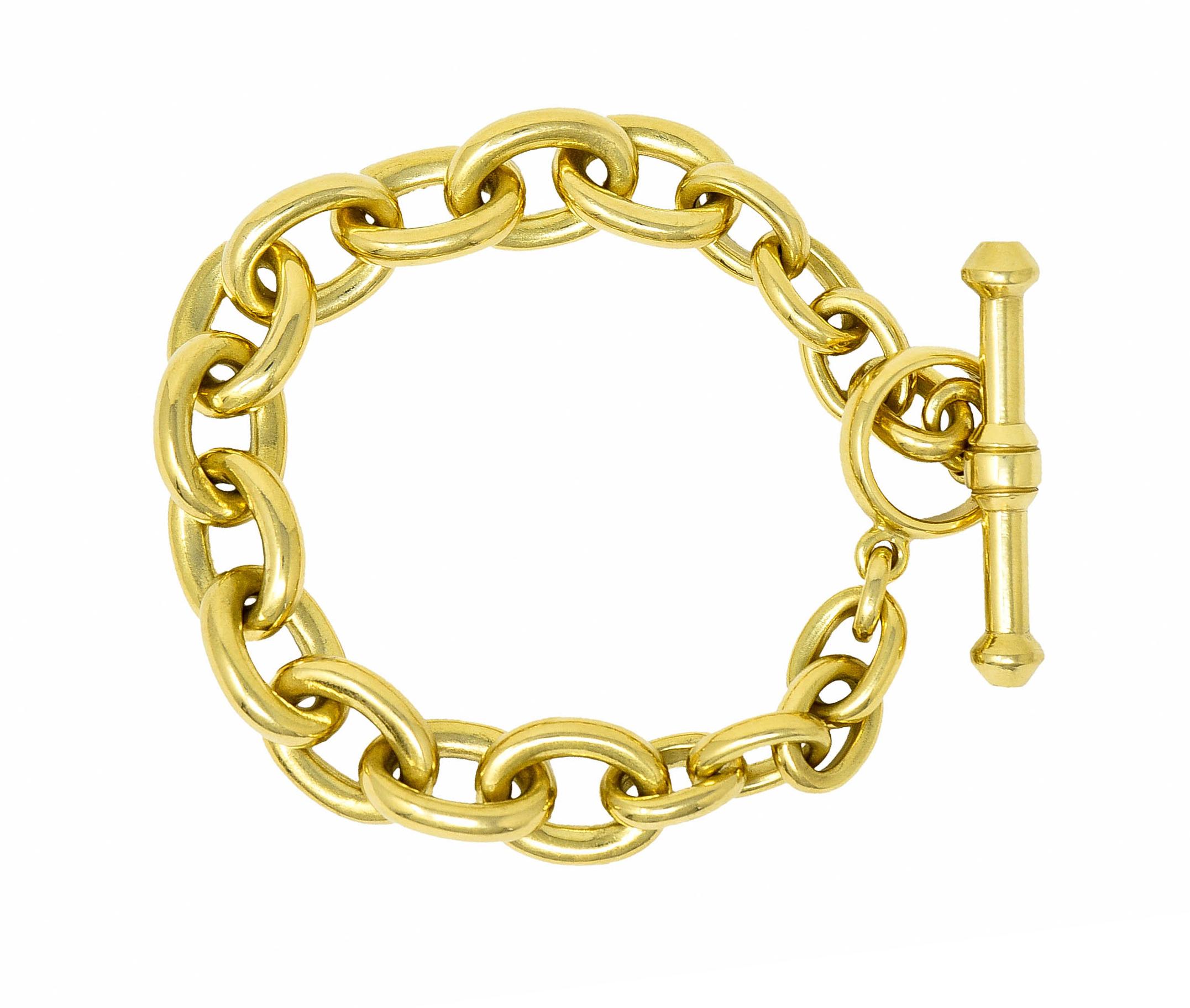 Bracelet is comprised of polished gold curb links

Completed by a stylized and oversized toggle bar clasp

Stamped 18K for 18 karat gold

Maker's mark and fully signed Kieselstein Cord

Inscribed origin USA and dated 1984

Length: 8 1/4