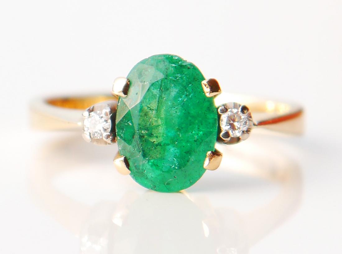 Ring in solid 18K Yellow Gold with natural deep Green Emerald stone : oval diamond cut 9 mm x 7 mm x 4.5 mm deep/about 2ct. accented with two diamond cut Diamonds 2.25 mm / 0.04 ct each set in white Gold or Platinum clusters.

Made in