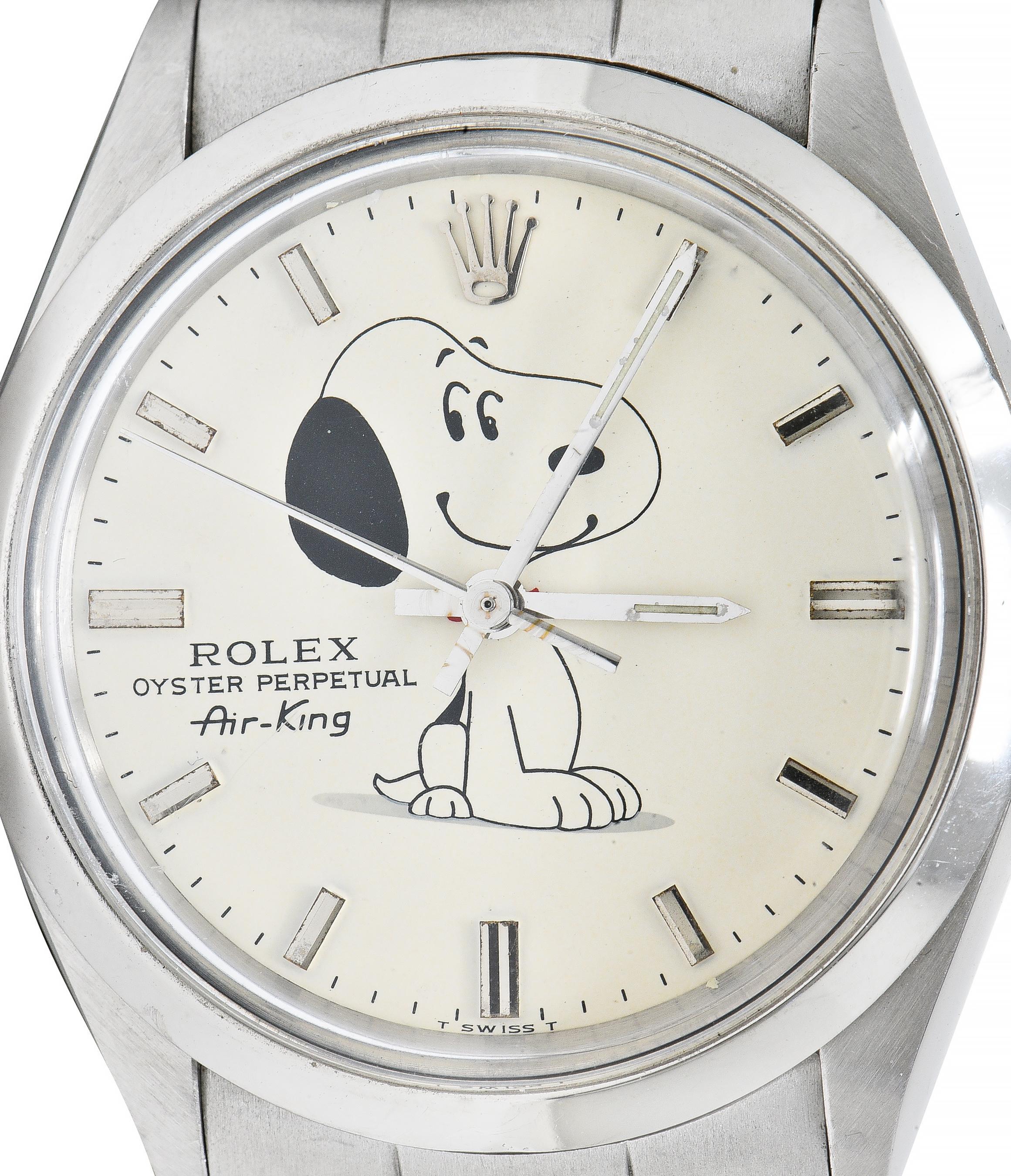 Centering a round cream-colored concentric dial watch face featuring steel stick numerals 
Centering a linear illustration of the Peanuts character Snoopy - sitting with a smile and raised eyebrows
With 'Rolex Oyster Perpetual Air King' and 'Swiss '