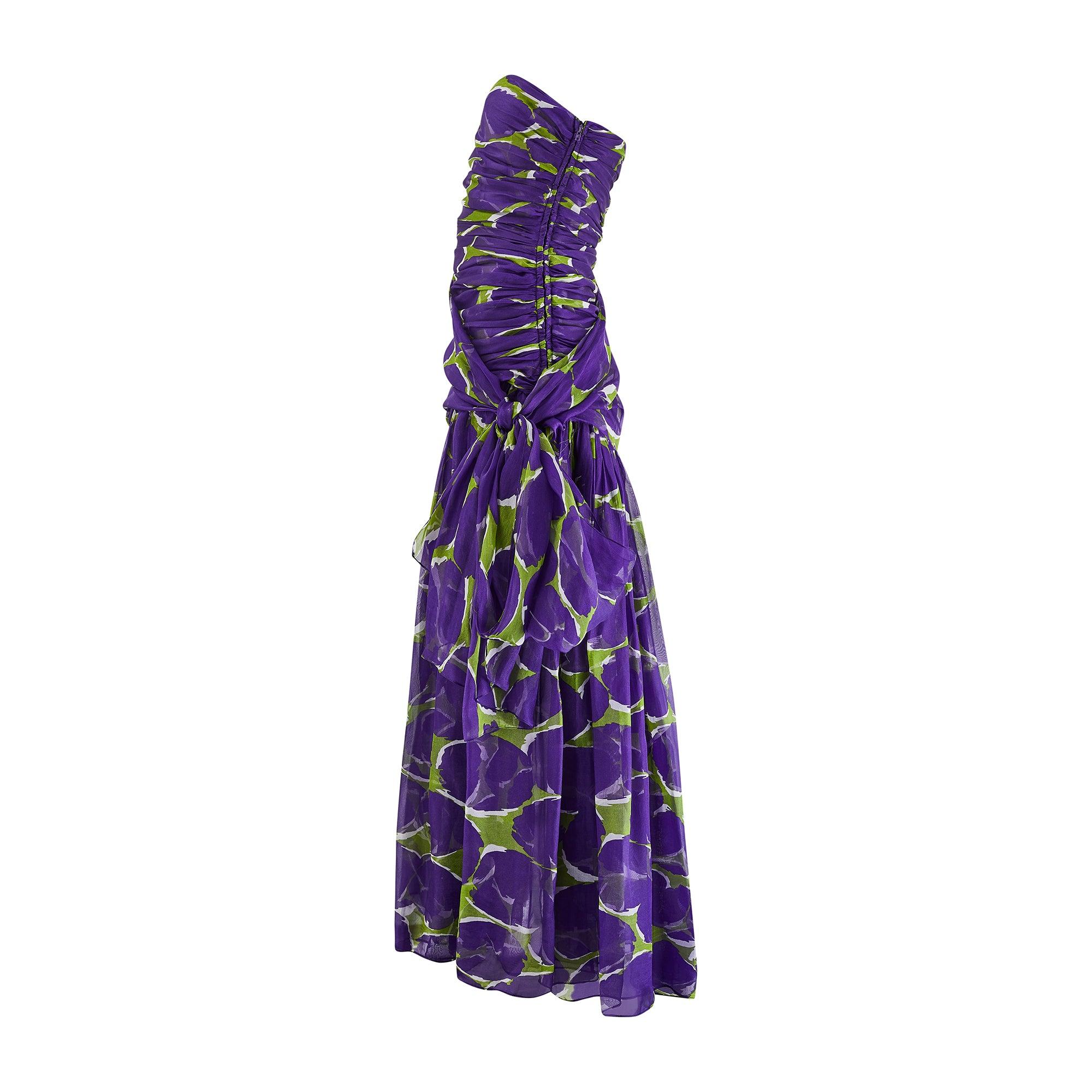 This incredible, documented dress walked the runway as part of Yves Saint Laurent’s much sought-after 1984 collection. The fabric is a real head-turner; swathes of rich purple sheer chiffon are cut-through with painterly strokes forming abstract