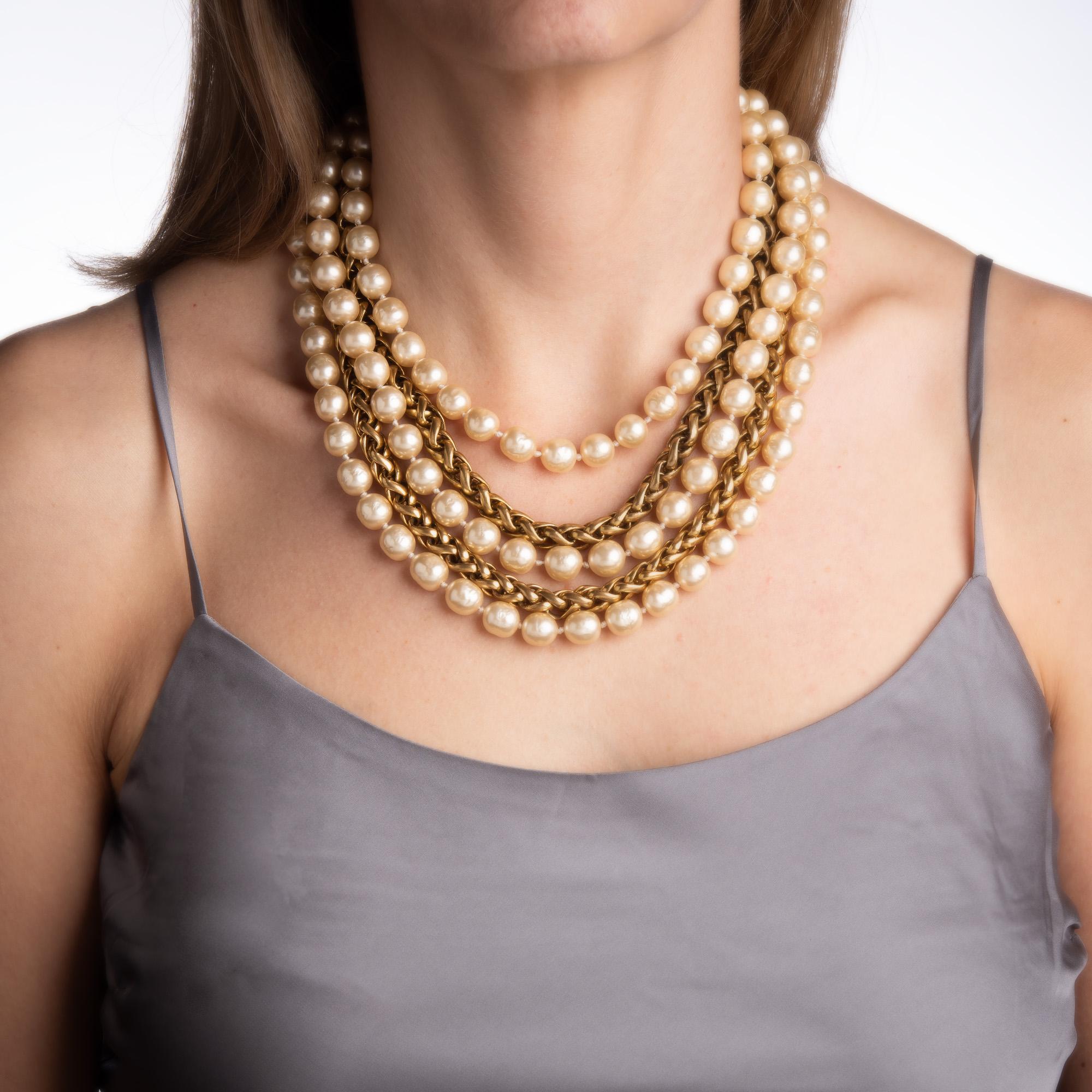 Vintage Chanel multi-strand necklace crafted in yellow gold tone (circa 1984). 

The necklace features 3 strands of 10mm faux pearls with 2 strands of yellow gold plated wheat-style chains. Measuring 17 inches in length the necklace is slightly