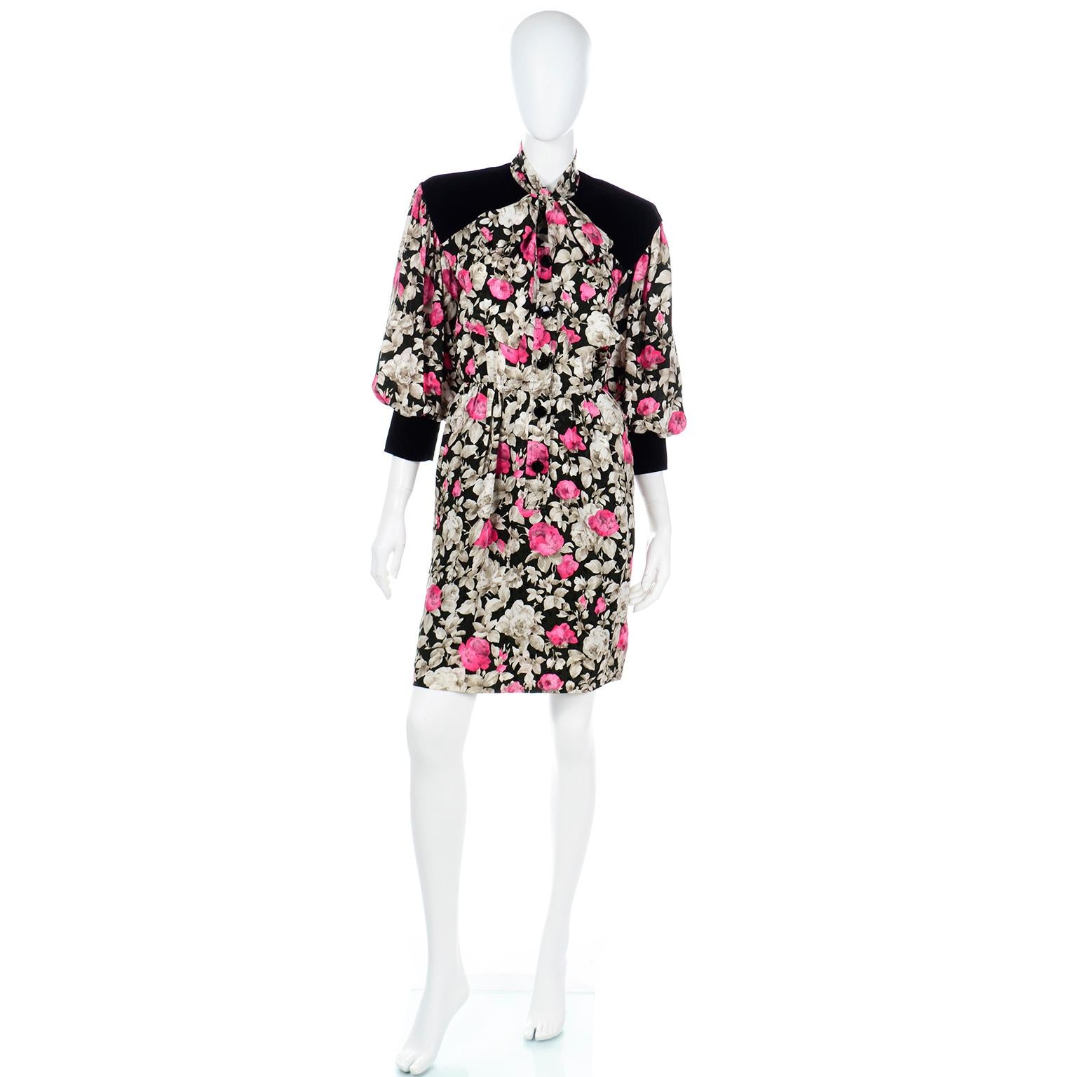 This iconic Yves Saint Laurent dress is in a fine floral silk in shades of dove grey and pink on a black background with black velvet trim at the cuffs, yoke and over the shoulders. This dress was featured on the 1984 YSL runway and was illustrated