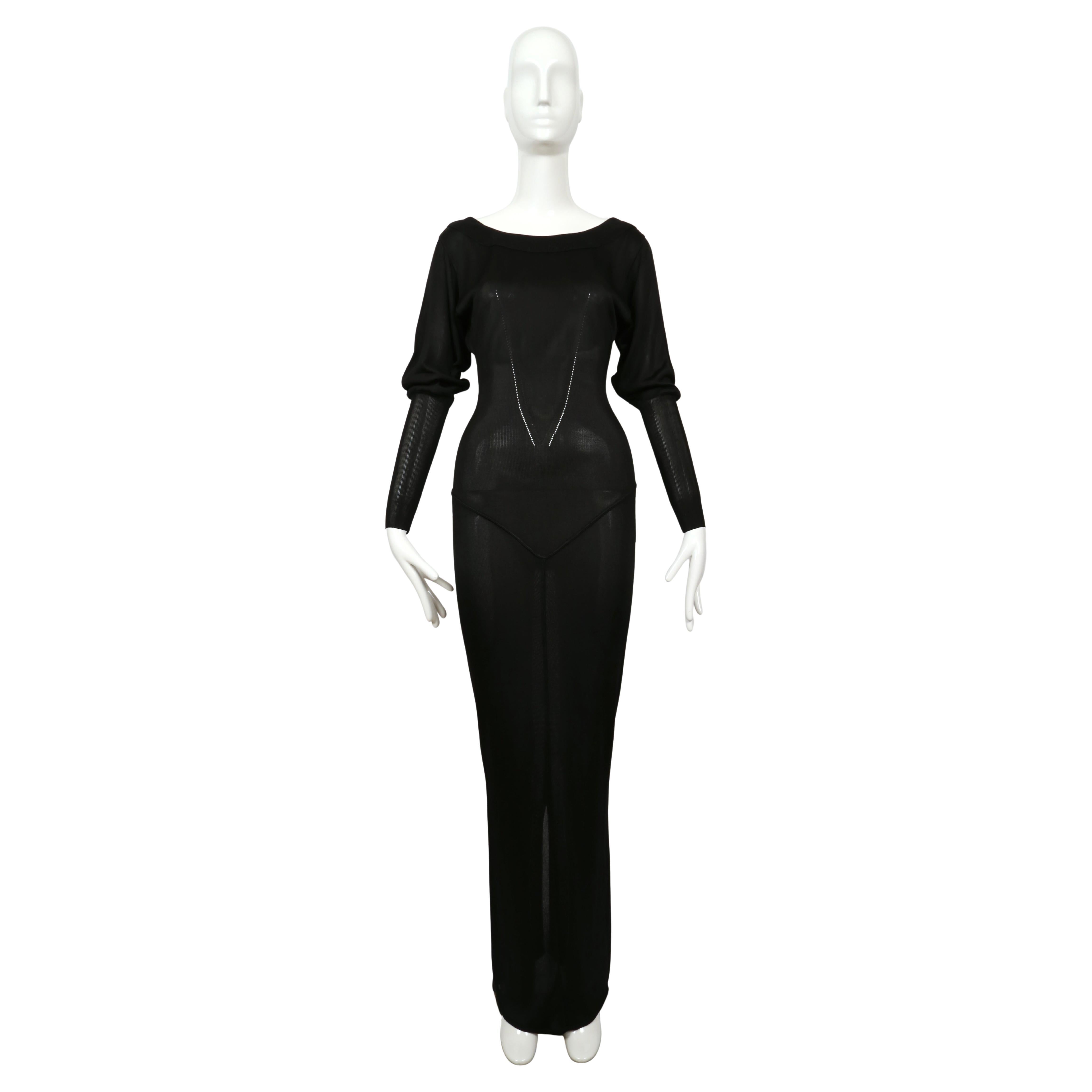 Very rare, jet-black, long sleeve knit dress  with batwing sleeves, pointelle knit accents and stunning seams from Azzedine Alaia dating to 1985. Size is ''S'. Approximate measurements (unstretched):  shoulder 15-16