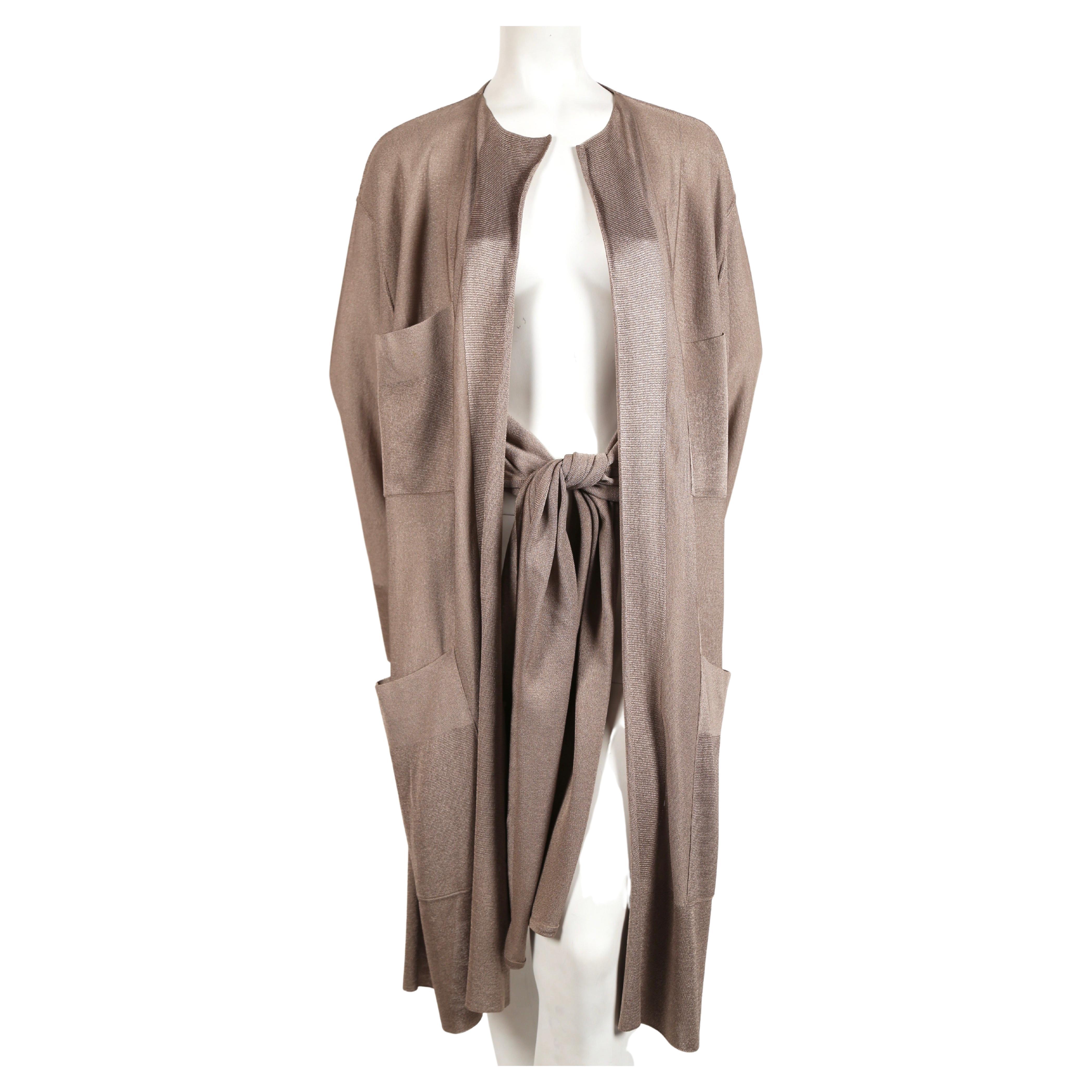 Taupe knit jacket with waist ties designed by Azzedine Alaia dating to spring of 1985. Looks great belted or worn loose. Labeled a size Medium. Approximate measurements laying flat: shoulder 20