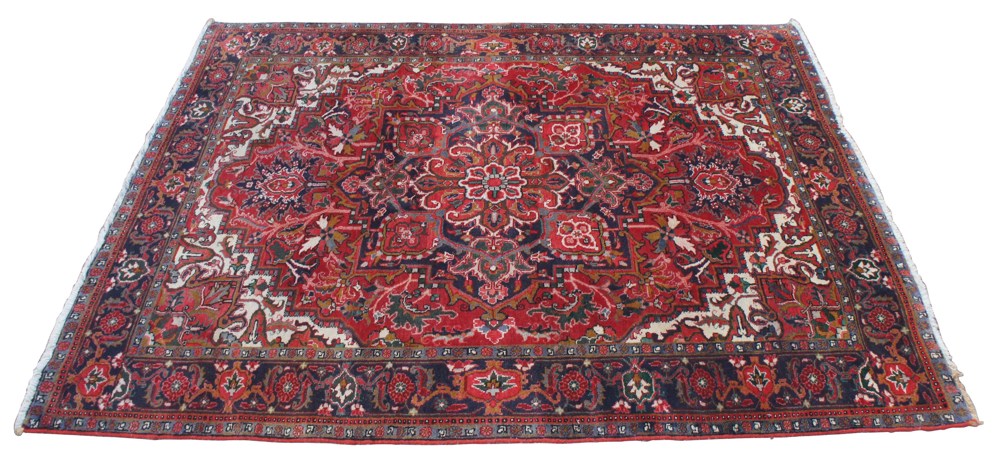 Vintage 1985 Bakhtiar area rug. Made in Iran of 100% wool, featuring a large central medallion with an flloral motif over a field of reds with blues / teal, tans, pinks, greens, brown / gold, and indigo / purple. Measures: 6.5' x 9'.
  