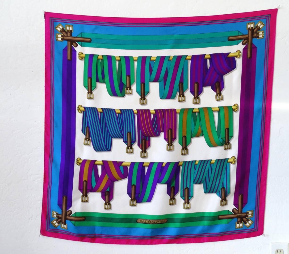 The most amazing 1980s Hermes silk scarf in the 'Les Sangles' print, designed by Joachim Metz! Bright, oh-so 80s color way in shades of blue, teal, magenta and purple! Unique multicolored striped belt and buckle pattern with solid striped border.