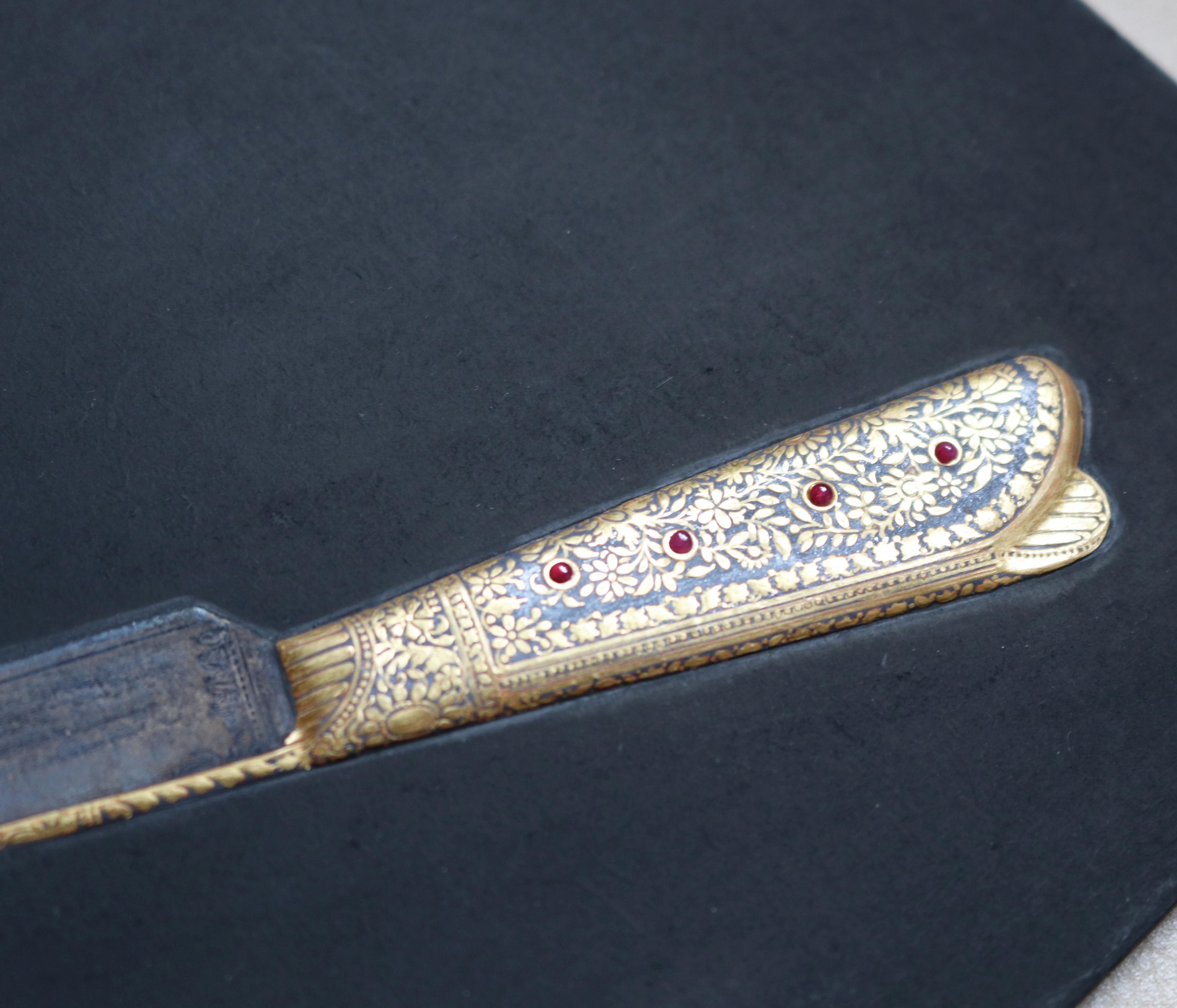 1985 hyperrealist relief painting of a hand drawn flower decorated dagger using vivid colors, including gold gilding. Signed Ramesh Sharma.
 