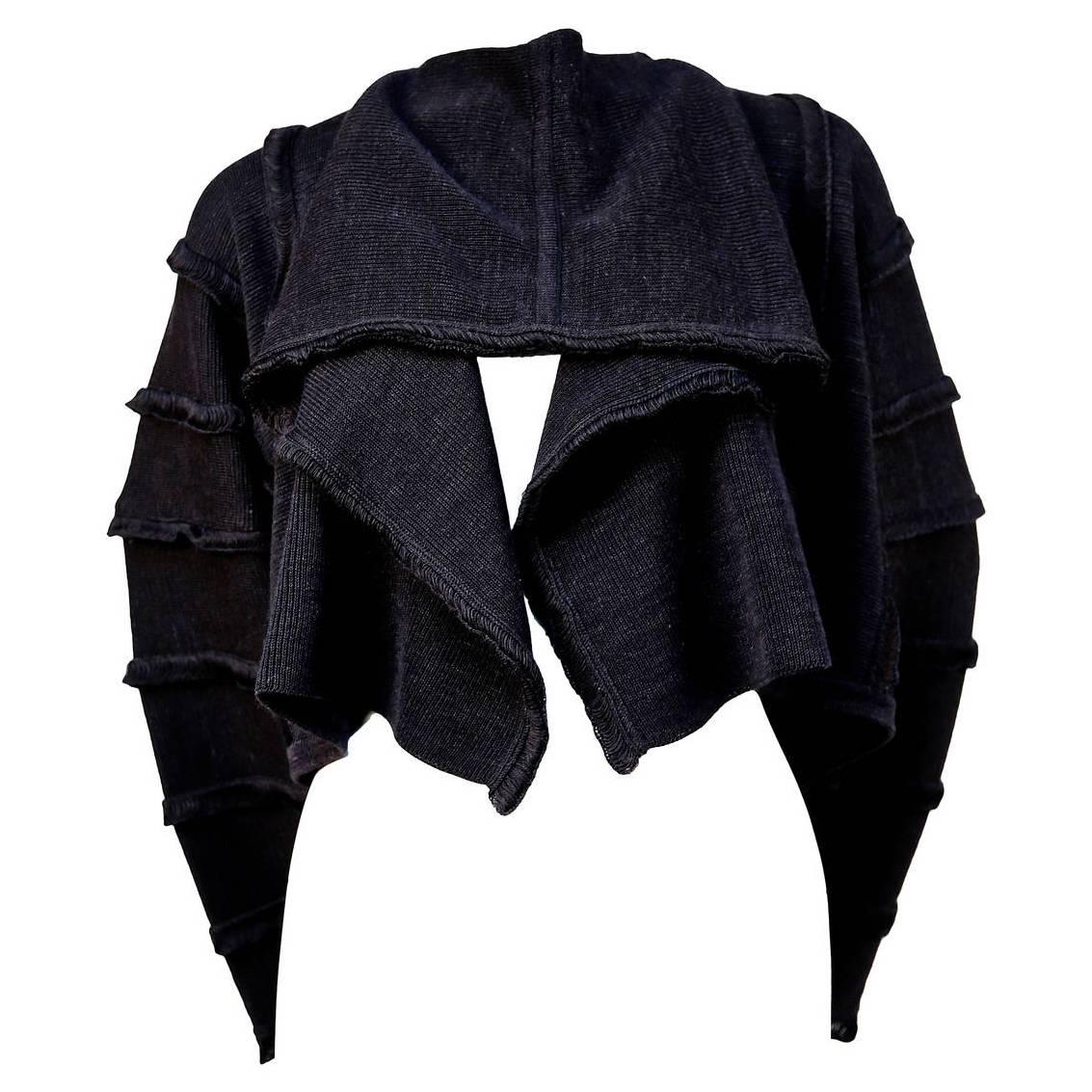 Very rare and unique draped knit sweater in charcoal/black from Issey Miyake dating to the spring of 1985. Many similar versions were seen on the Miyake Spring 1985 runway.  Size 'M'. Measurements are difficult to take but the neck is slim. Slips on