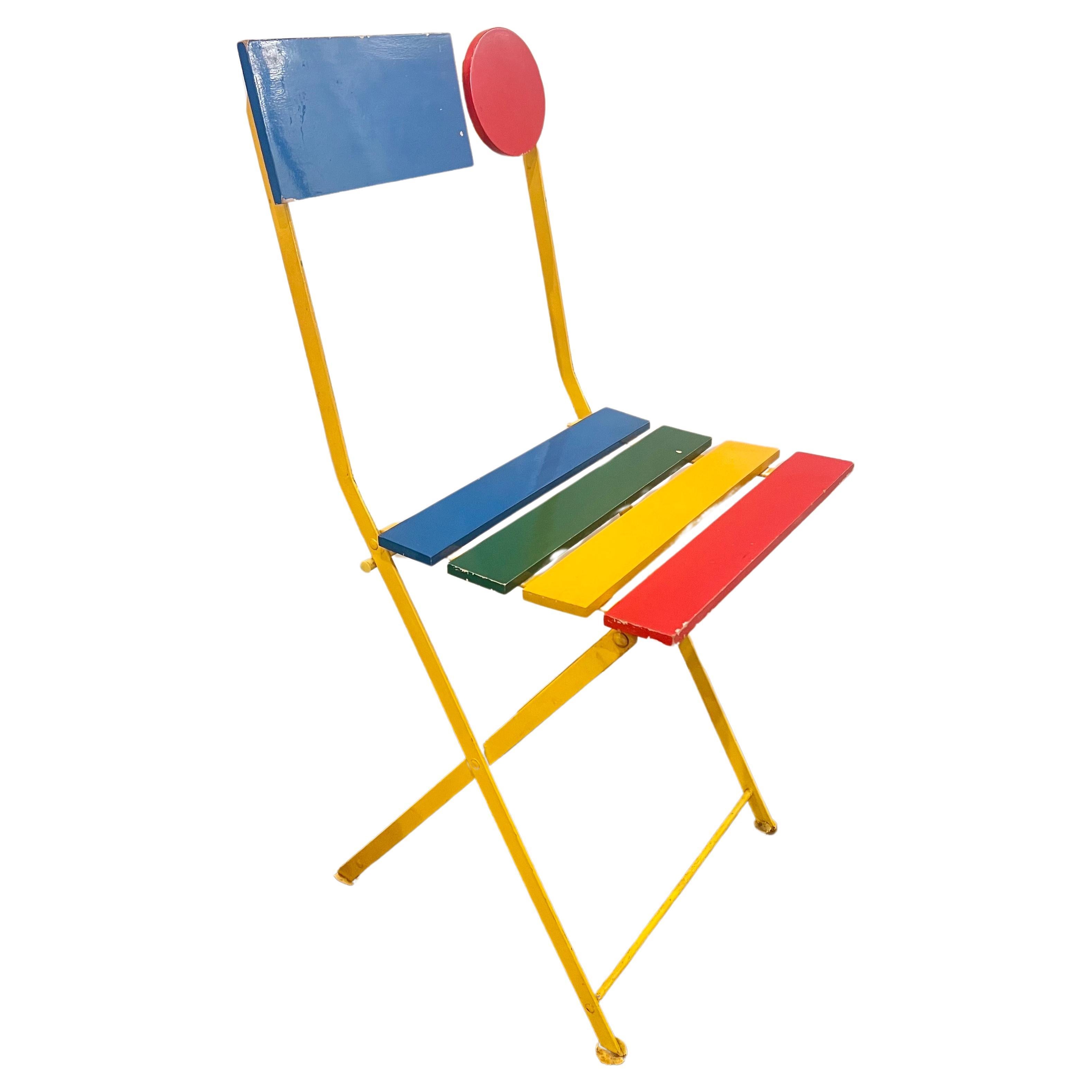 Whimsical folding chair rare hard to find, Lacquered steel frame with plastic rollers for folding, seat and back of lacquered wood slats. Designed by Denis Balland for Fermob, France, c. 1985. Great as a side chair it is a sculpture by itself solid