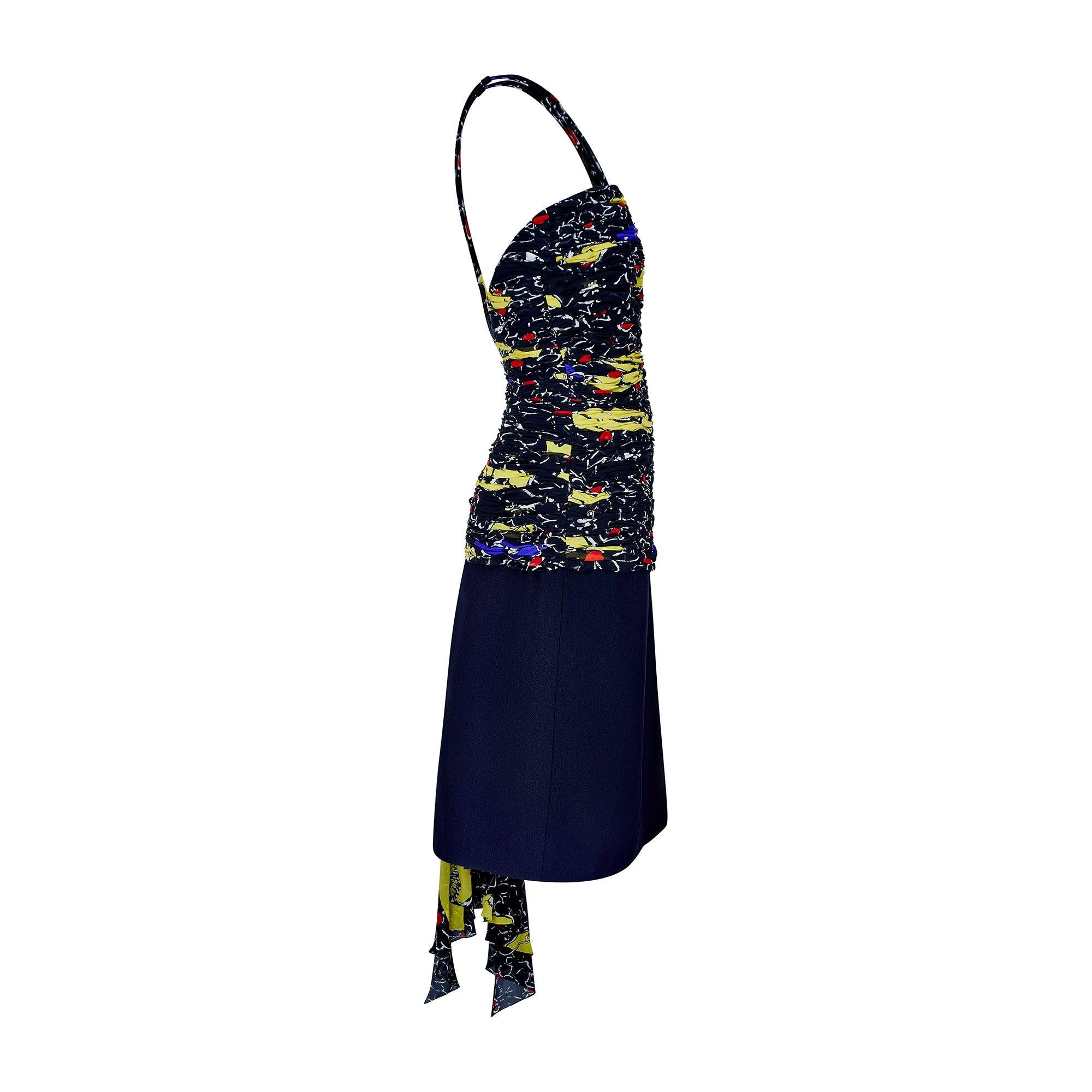 Made in Italy, this vibrant patterned party dress walked the runway for Valentino’s Spring 1985 collection.  At the bust, a frothy chiffon overlay sits over a simple strapless dress silhouette. The black chiffon is patterned with painterly florals