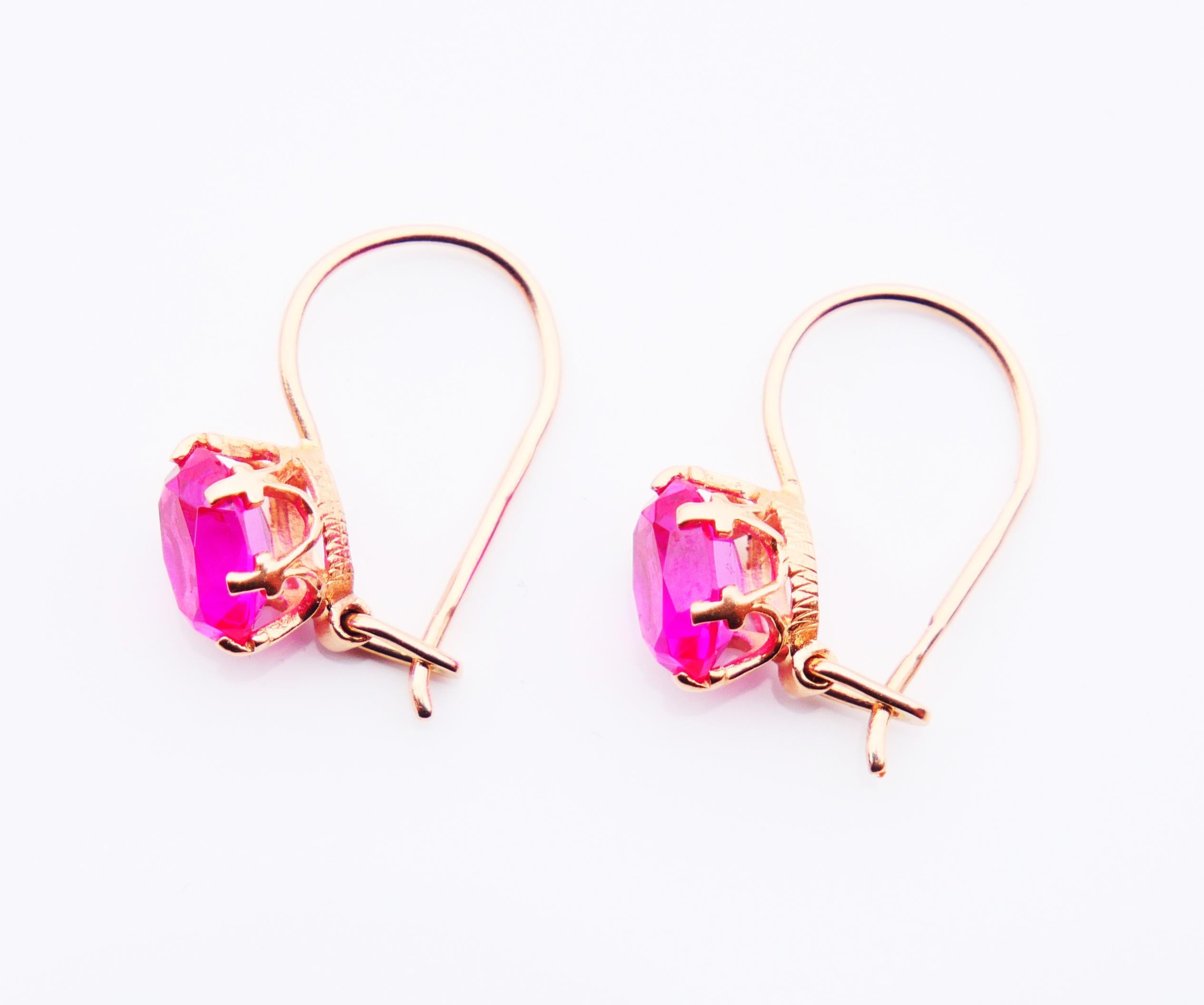 Dangle Earrings in 583 / 14K Rose Gold with lab made Ruby settings made at the jewelry factory of Odessa, Ukraine,Soviet Union. Both show sharp Soviet period hallmarks, 585 Gold, year hallmarks for 1985.

Each earring measures 19 mm long from the