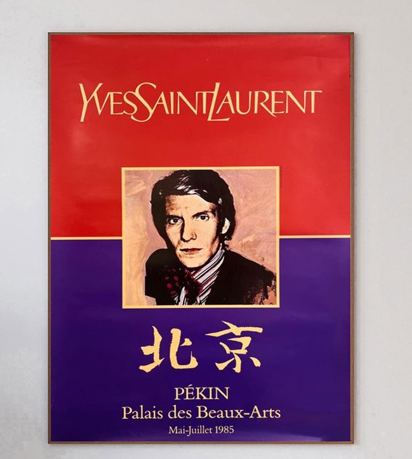 Gorgeous poster created in promotion of the 25 year retrospective exhibition of Yves Saint Laurent at the Palais des Beaux-Arts in Beijing, China - or Pekin as it was formerly known. This vibrant poster with gold features a portrait of the iconic