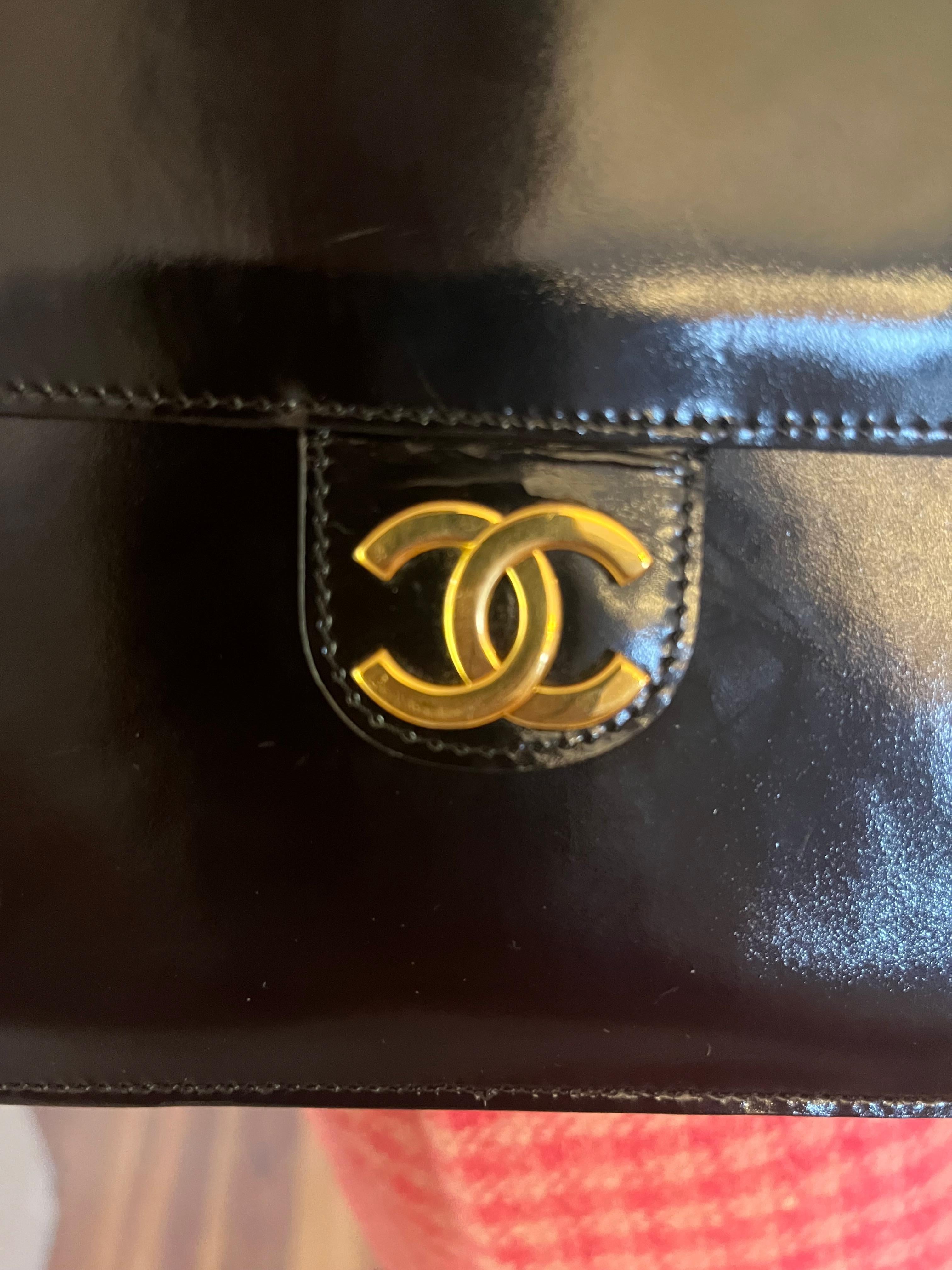 What a classic! This vintage 1986-88 black patent leather has a push lock closure. It is in amazing condition given its age with only a few minor scratches on the lining. The lining is a nice soft leather.
As we all know Chanel handbag prices have
