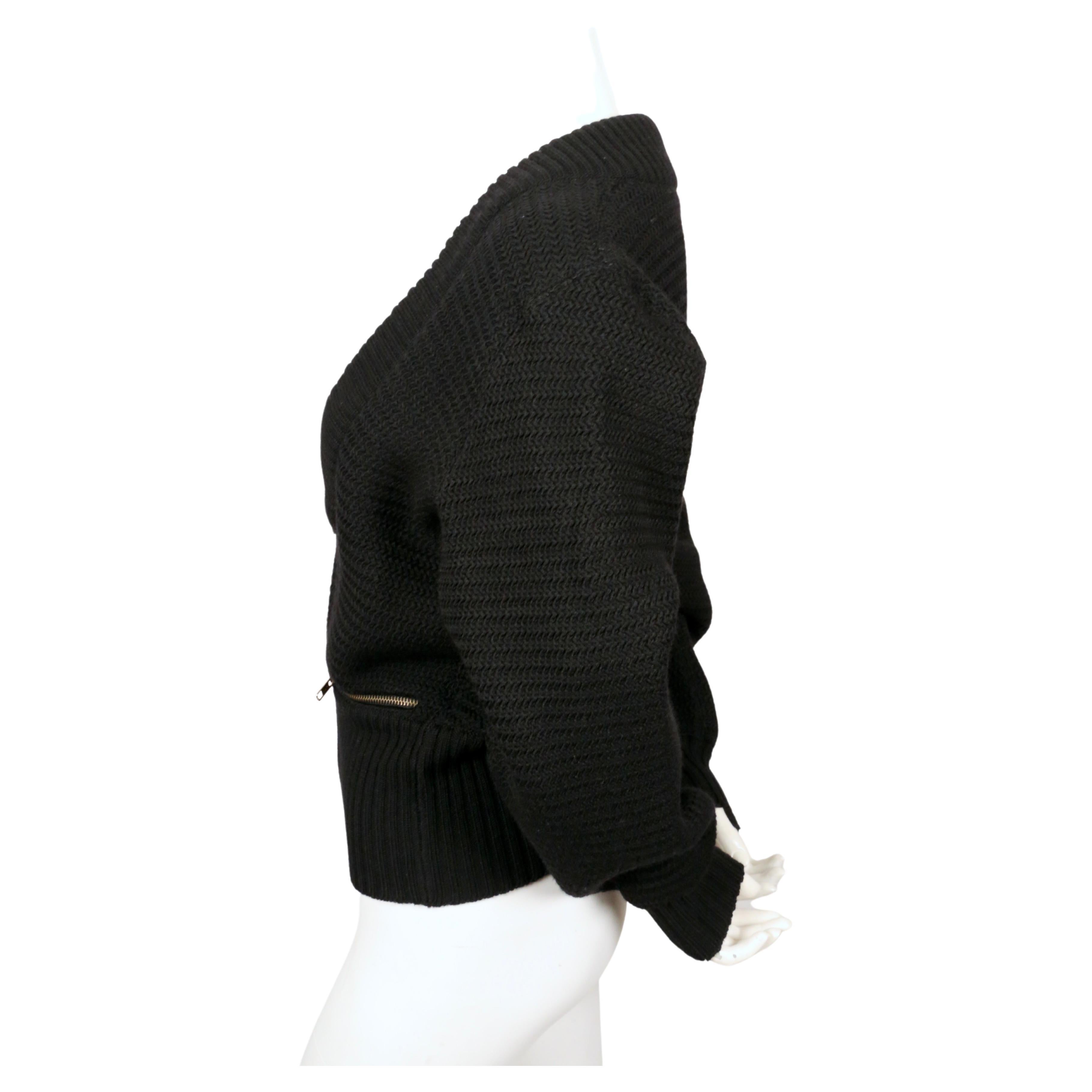 Black, densely knit wool cardigan sweater jacket with brass zippers and ribbed trim from Azzedine Alaia dating to fall of 1986 as seen on the runway. Size 'XS' although it can also fit a S. Approximate measurements: drop shoulder 19