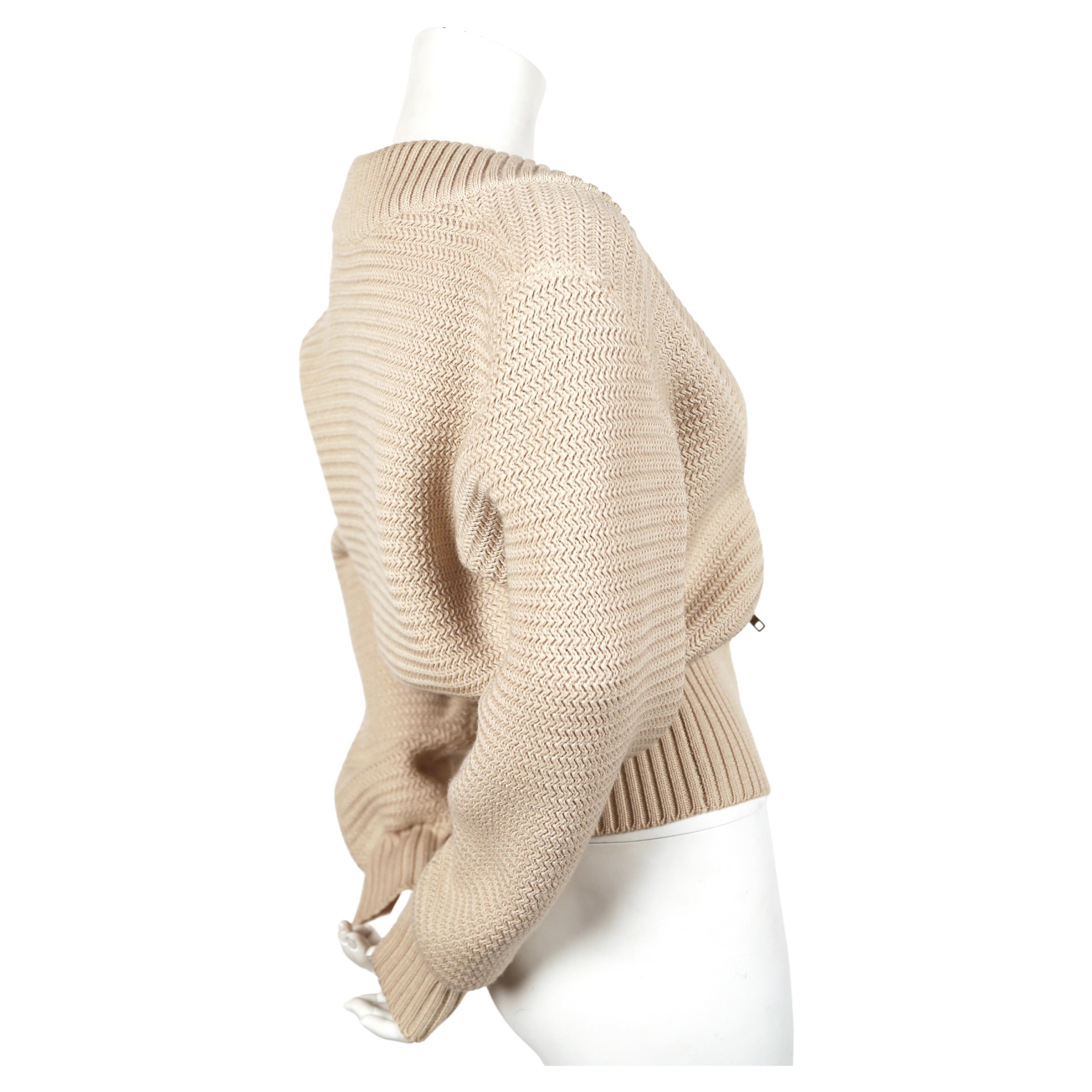 Off-white, densely knit wool cardigan sweater jacket with brass zippers and ribbed trim from Azzedine Alaia dating to fall of 1986, exactly as seen on the runway. Size 'S'. Approximate measurements: drop shoulder 19