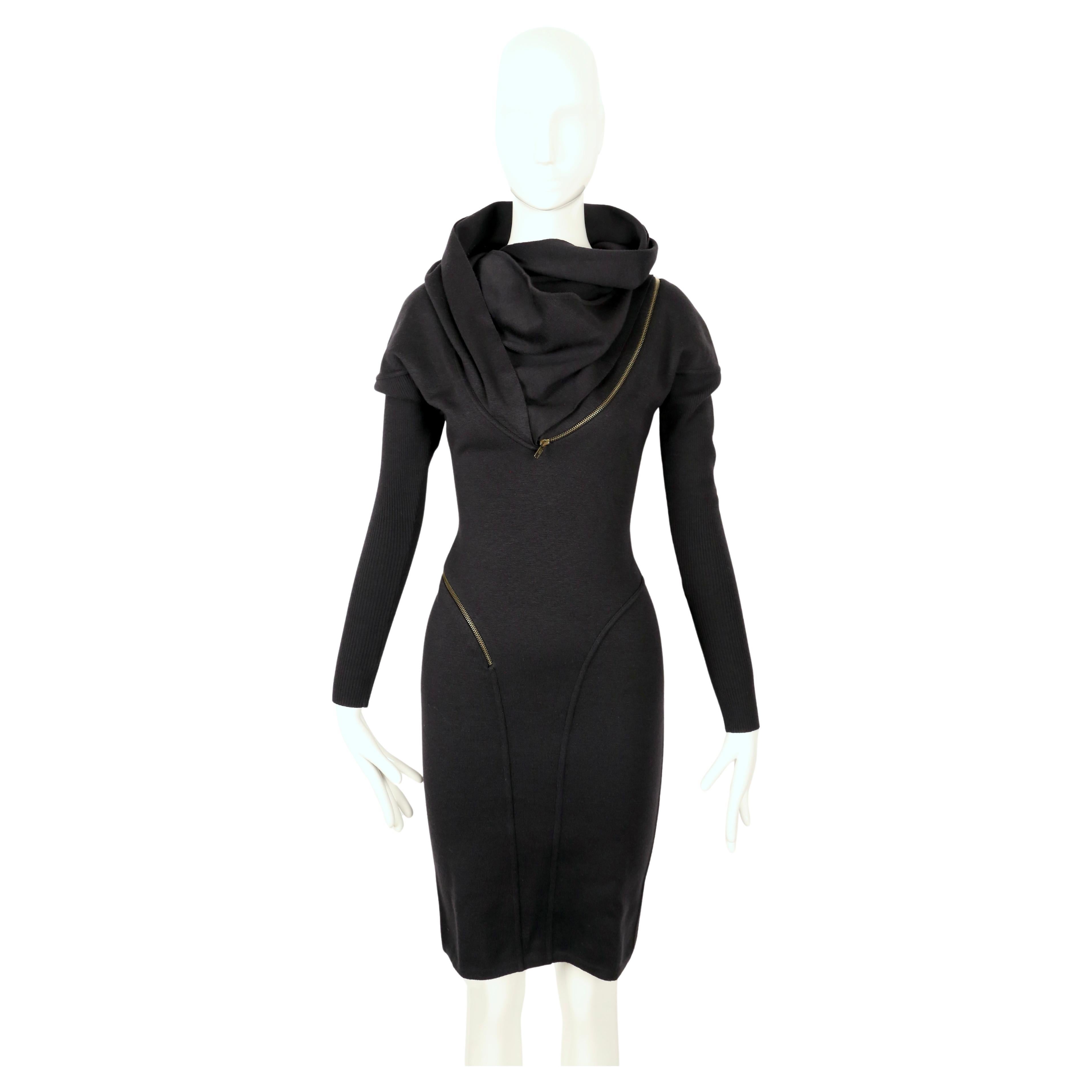 Iconic, jet-black wool, seamed, zipper dress with large hood designed by Azzedine Alaia dating to fall of 1986 exactly as seen on the runway. Well documented piece. Very flattering seams with spiral zipper that cleverly follows the contours of dress